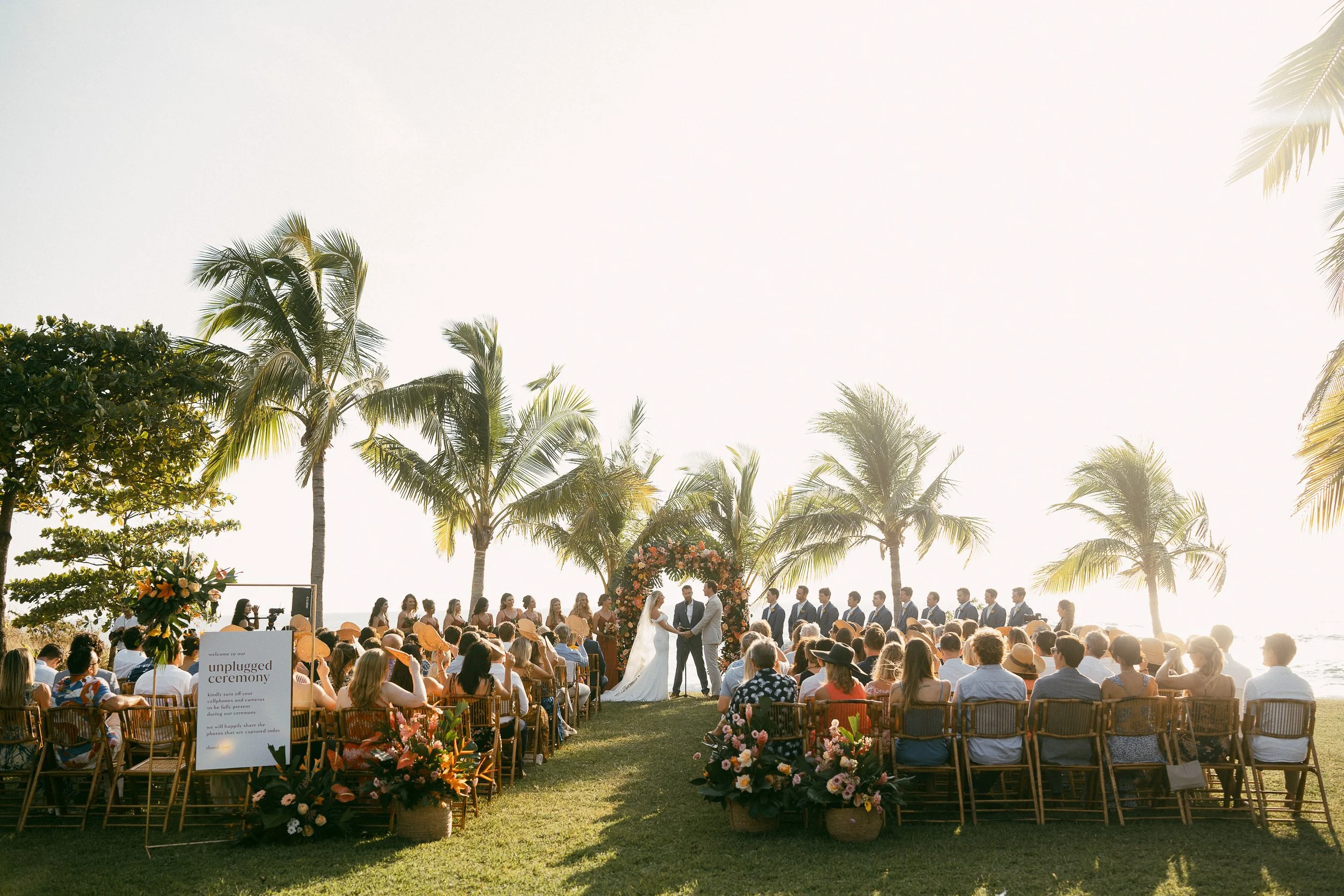 Tropical destination wedding reception with blush and terracotta floral décor at Hacienda Pinilla.