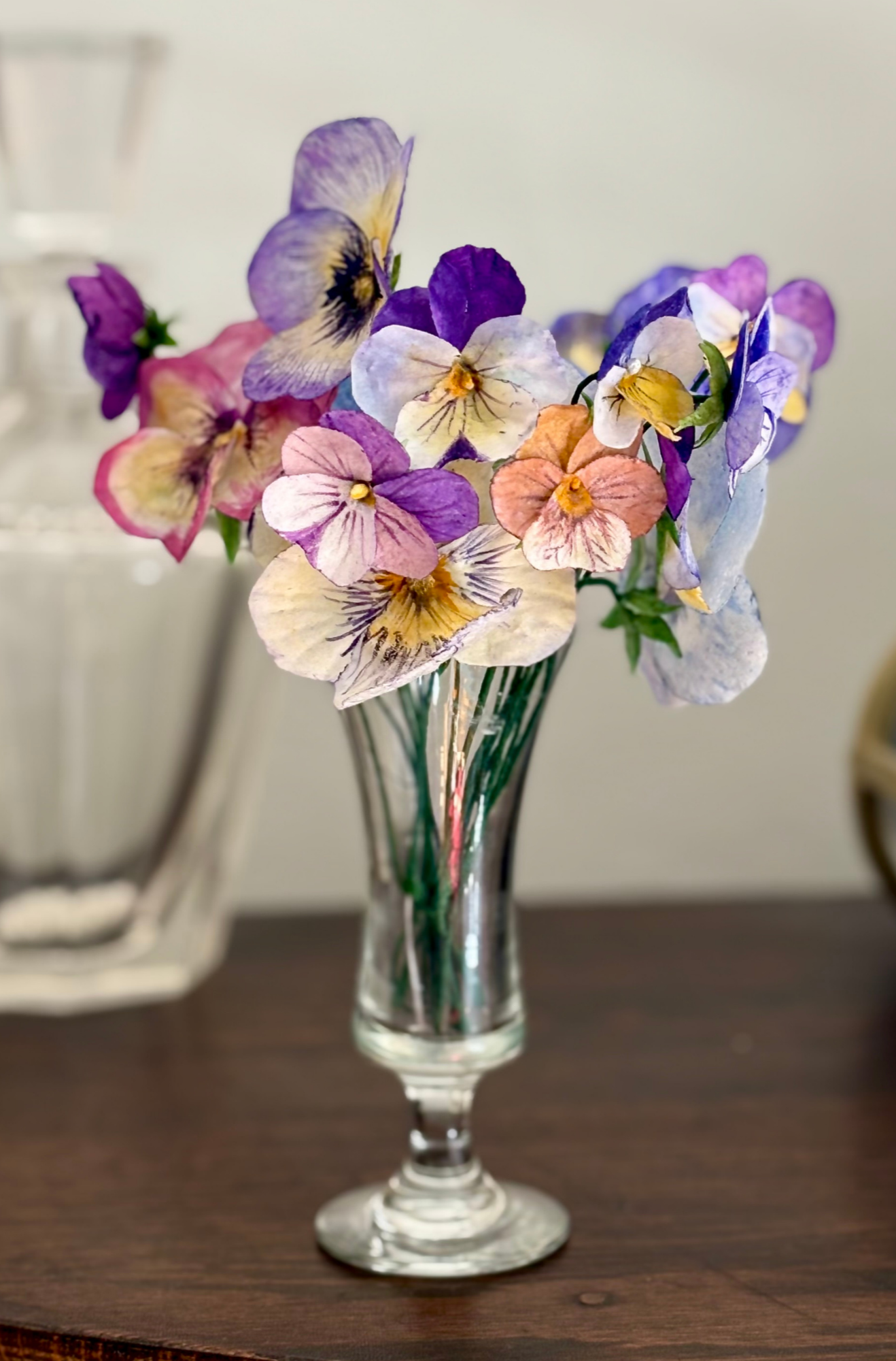 Small+glass+bud+vase+filled+with+purple%2C+white%2C+yellow%2C+and+orange+wafer+paper+pansies+and+violas.png