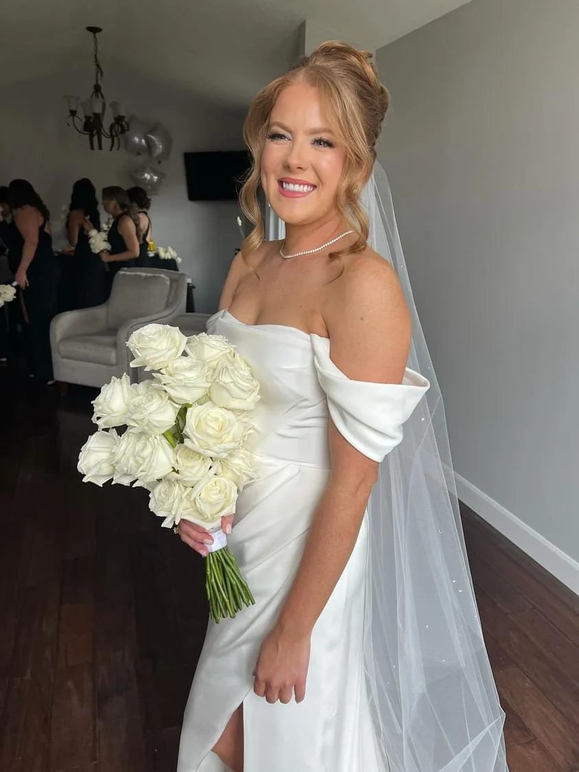 Smiling bride in her wedding dress with a spray tan