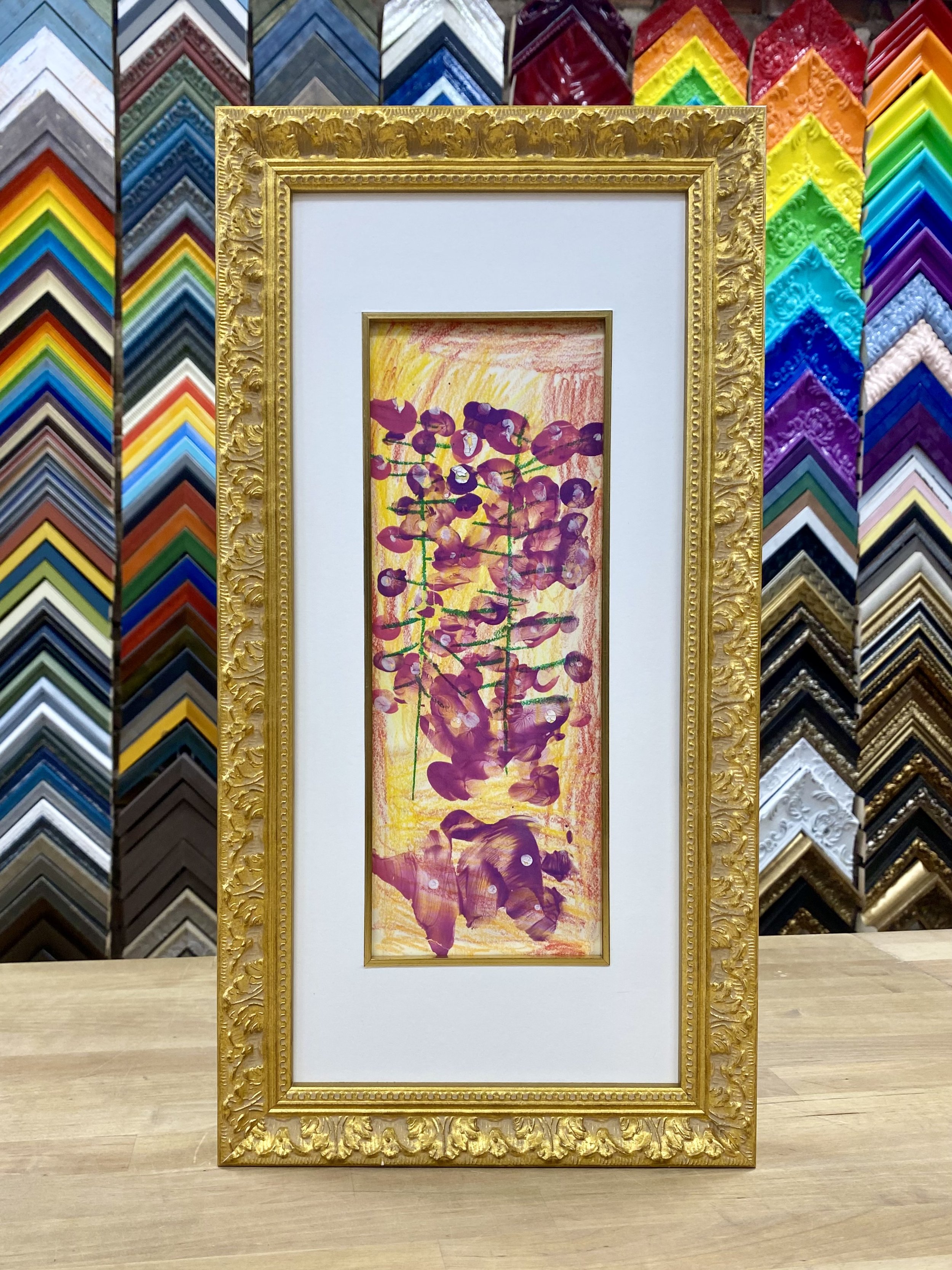   Do you have children’s artwork that is loved, cherished, and yet sitting in a drawer or folder? Have you considered custom framing these treasured pieces? Now is the time!     You can go fancy, with intricate gold leaf , mats and fillets (the tiny 