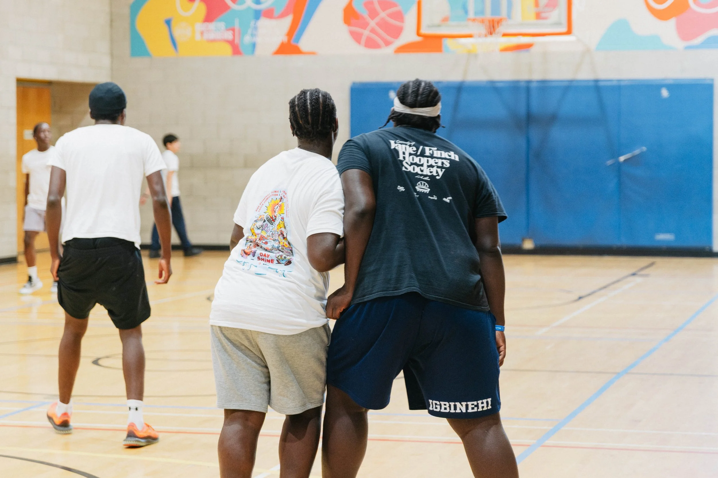 Two boys playing basketball in Jane-Finch