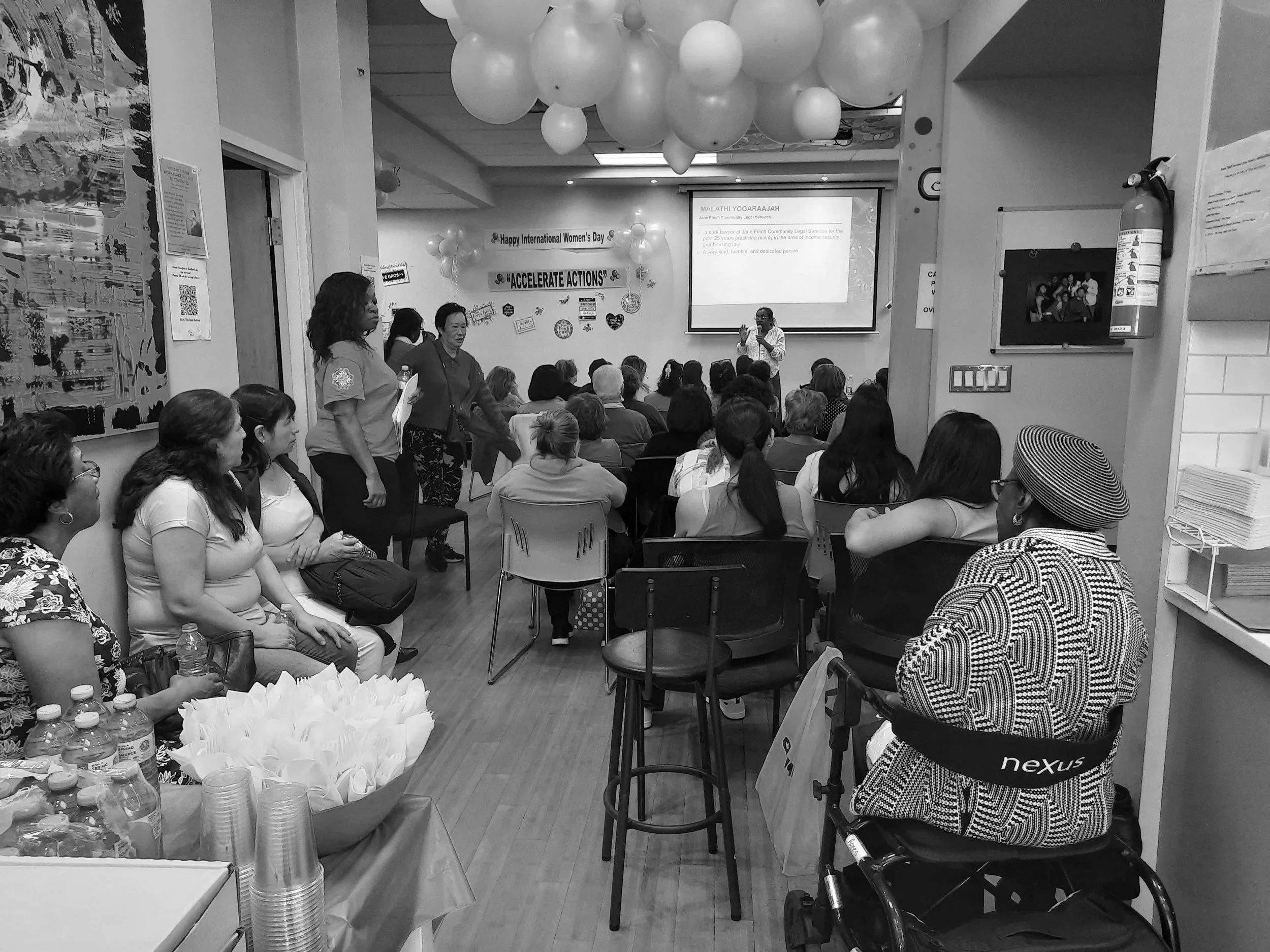 Newcomer participants listening to a speaker at a community event