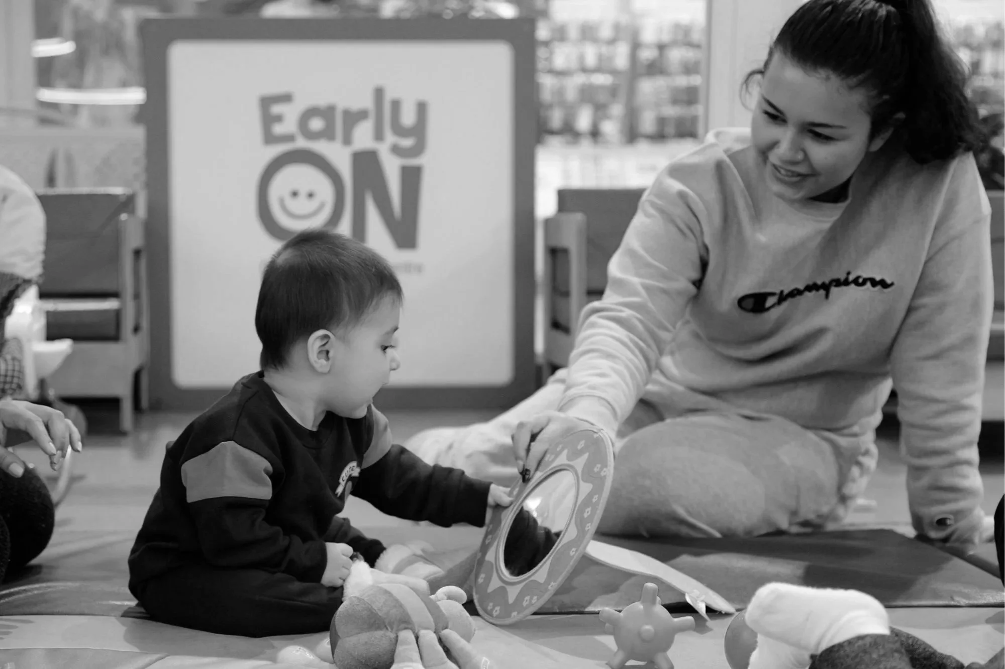 Adult and baby playing with a toy at the EarlyON Centre