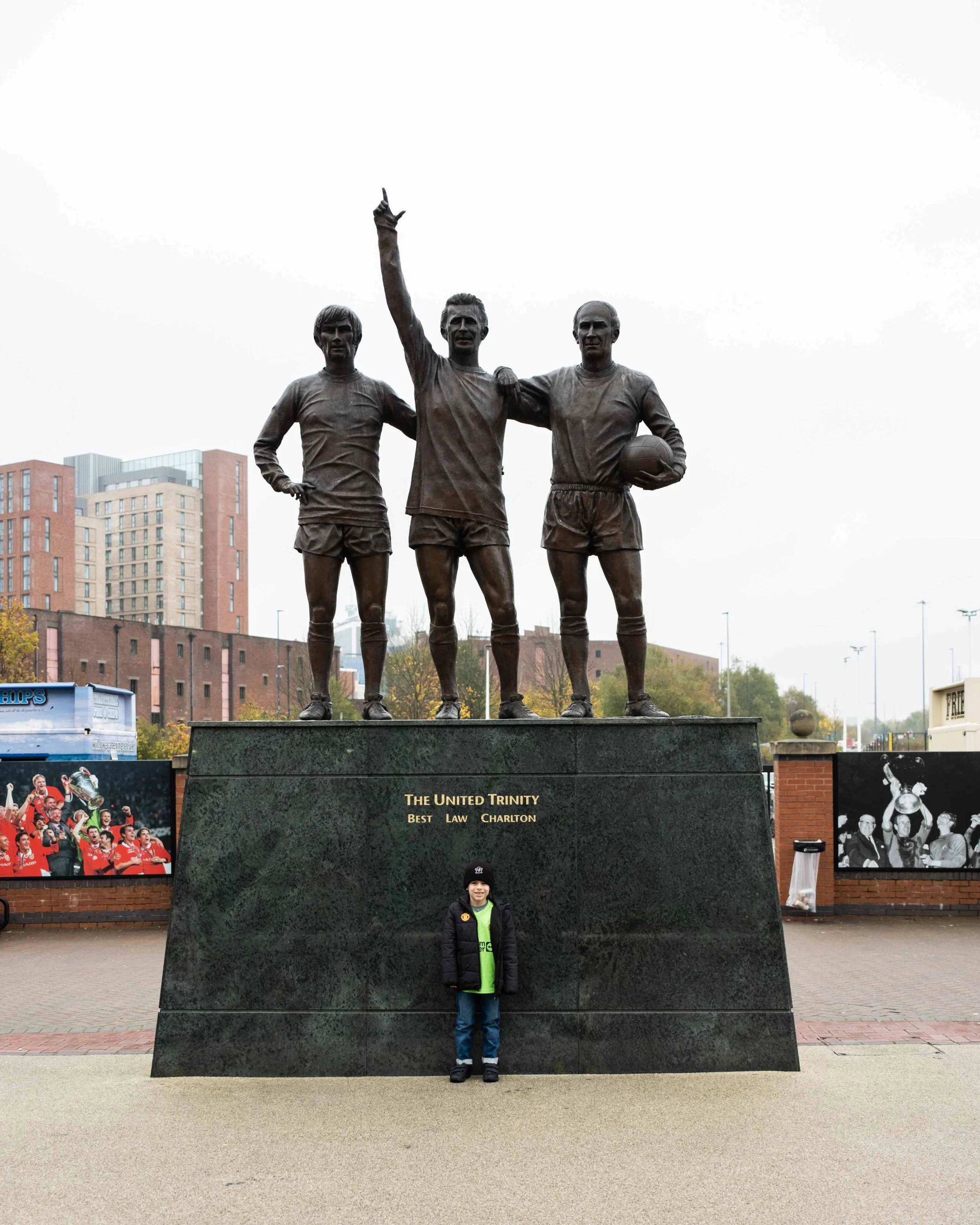 Ryan in front of the Holy Trinity statue outside Old Trafford