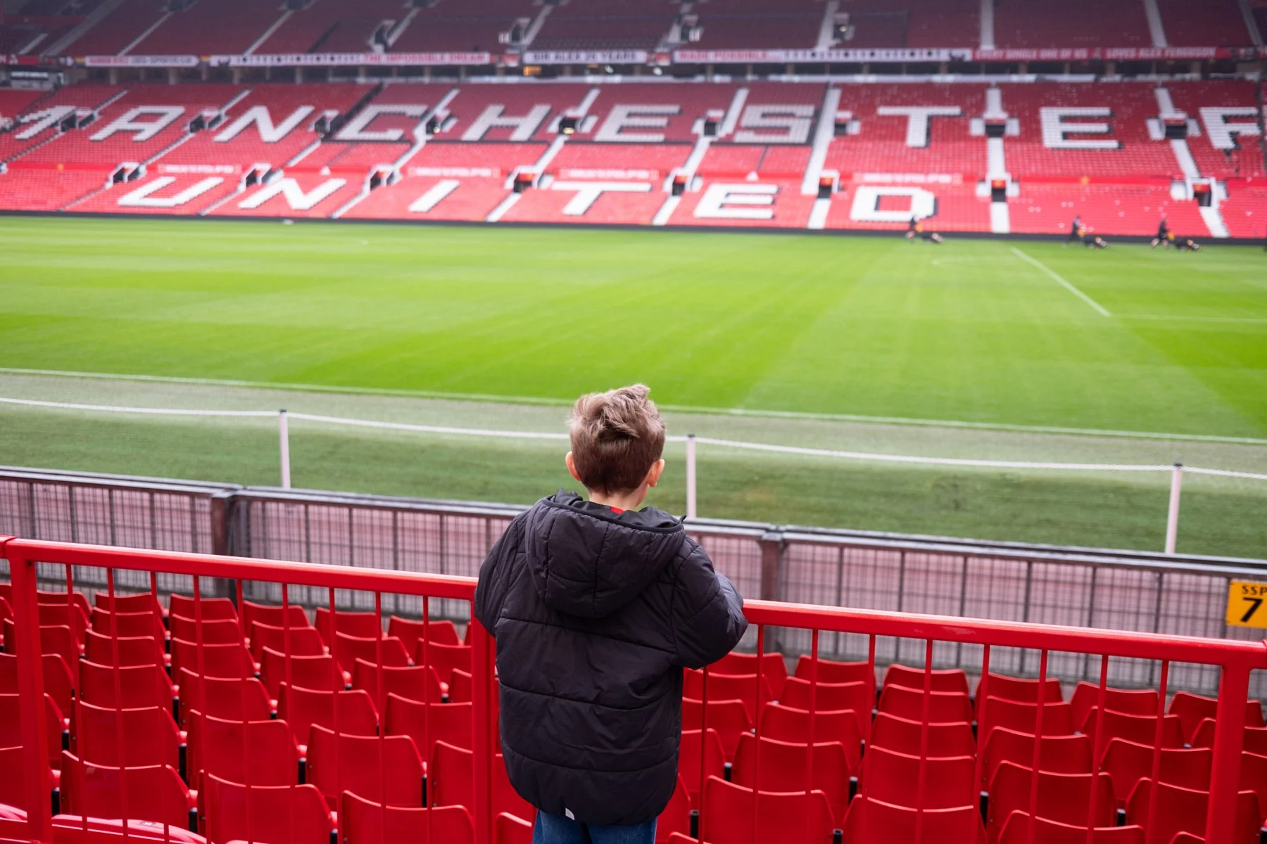 Child looking out onto the pitch at Old Trafford, home of Manchester United