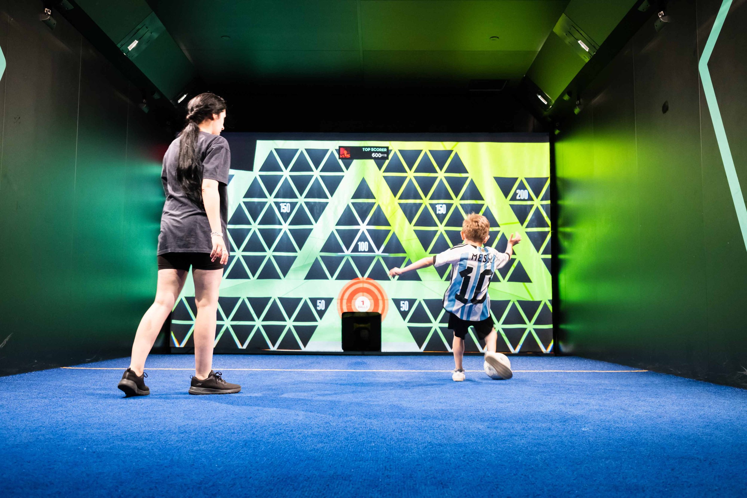 Family playing football games at TOCA Social The O2 London