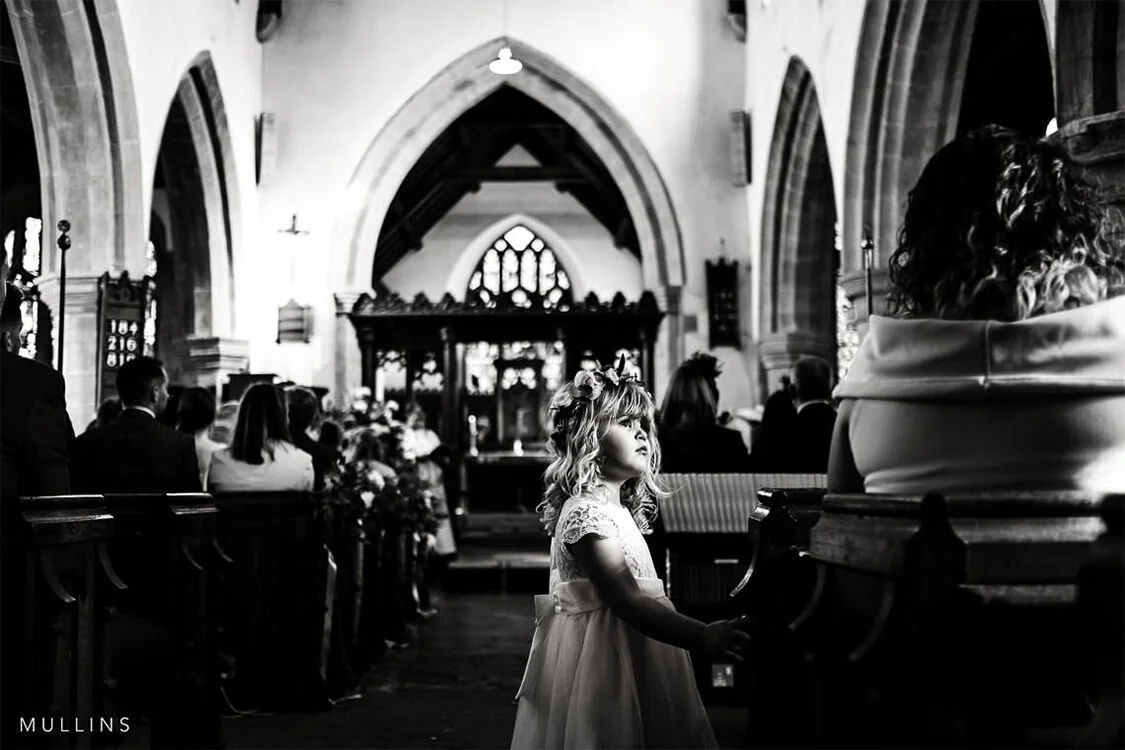 Wide documentary wedding ceremony photograph inside a church