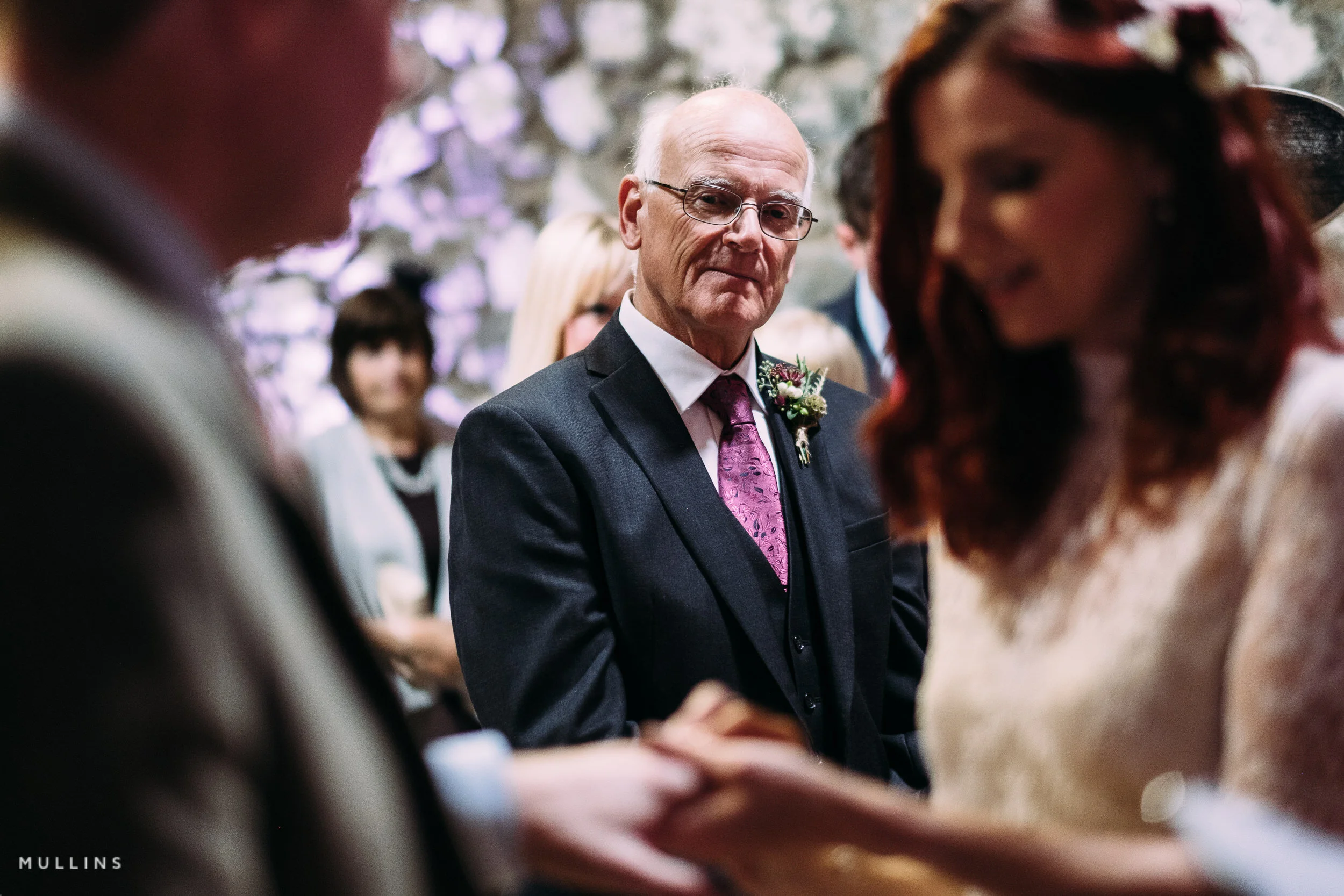 Dad watches his daughter at a wedding