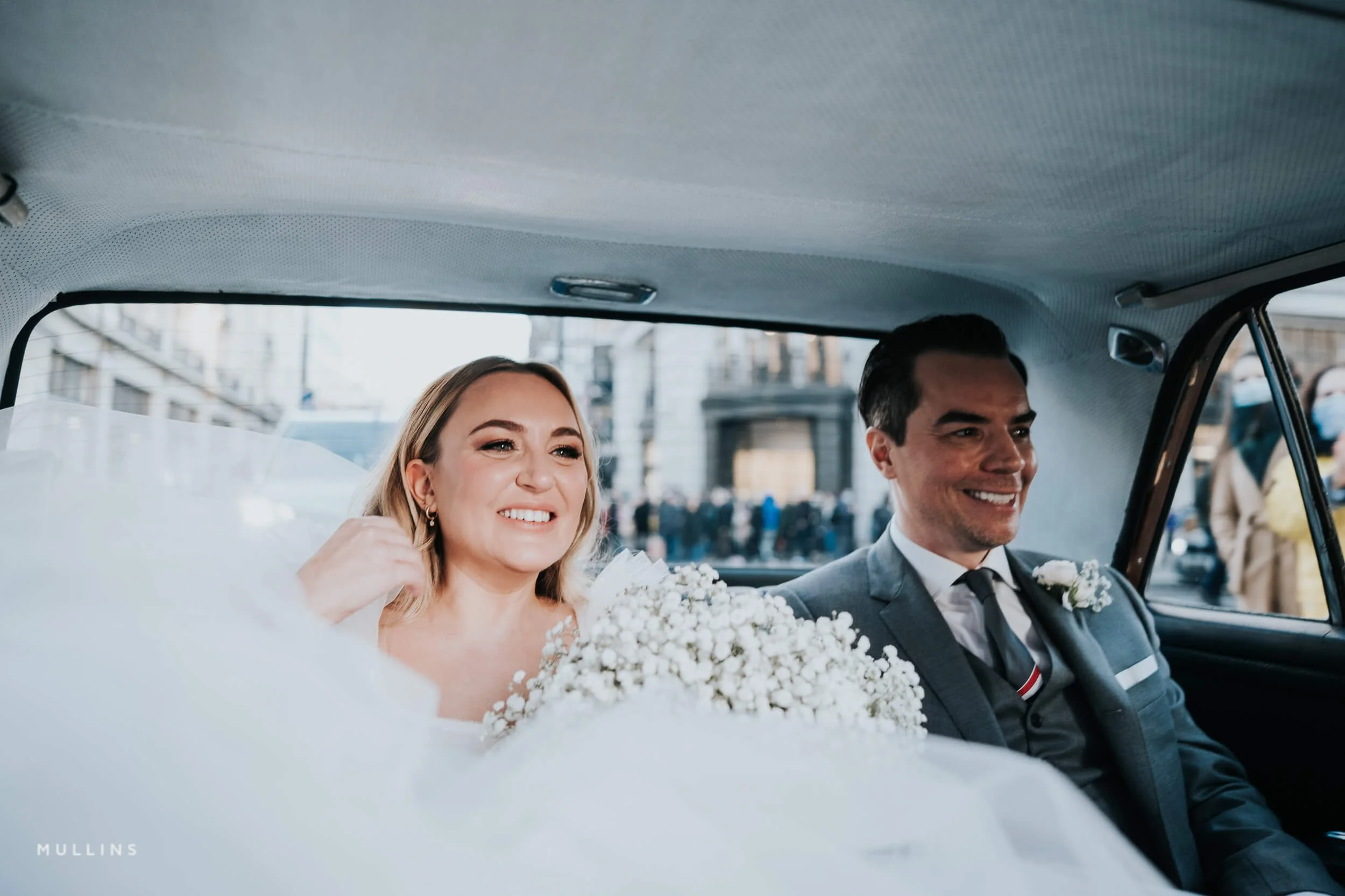 Bride and groom in wedding car