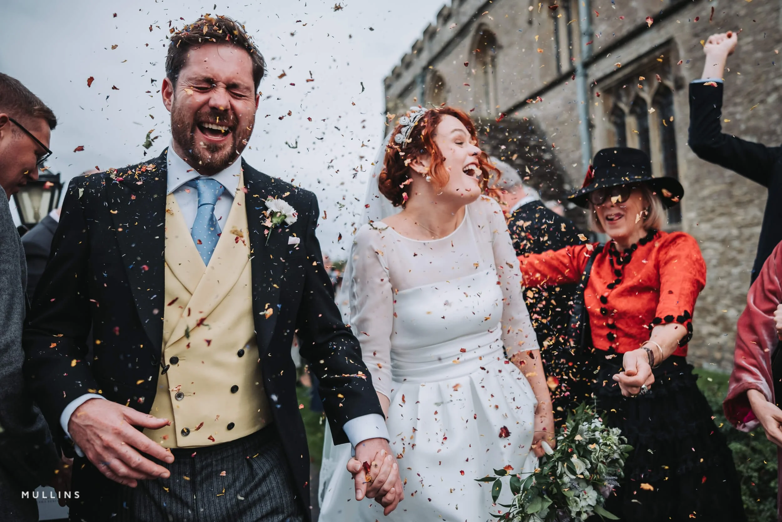 Bride and groom covered in confetti