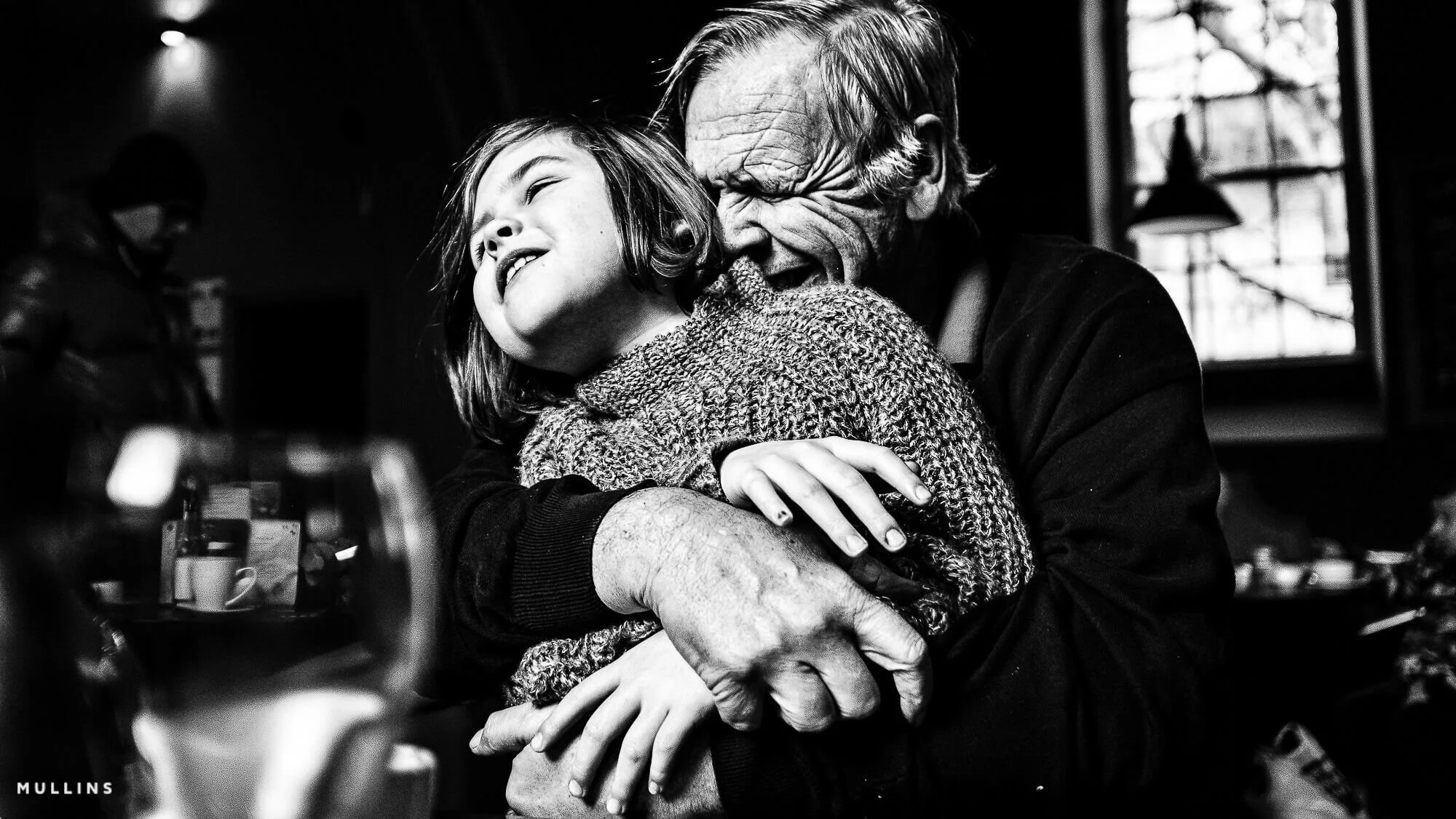 A grandfather plays with his granddaughter