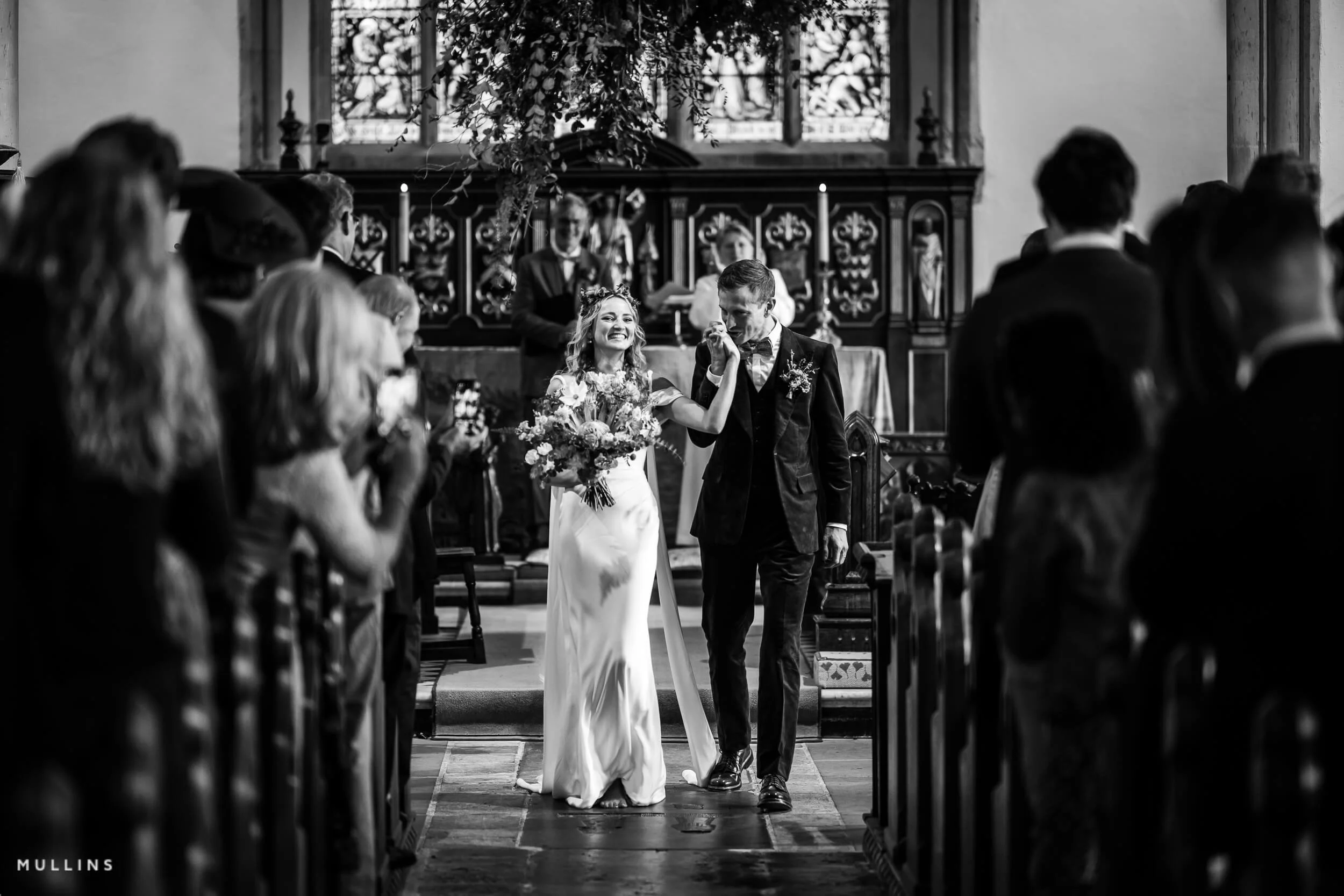 Bride and groom kissing during their wedding ceremony