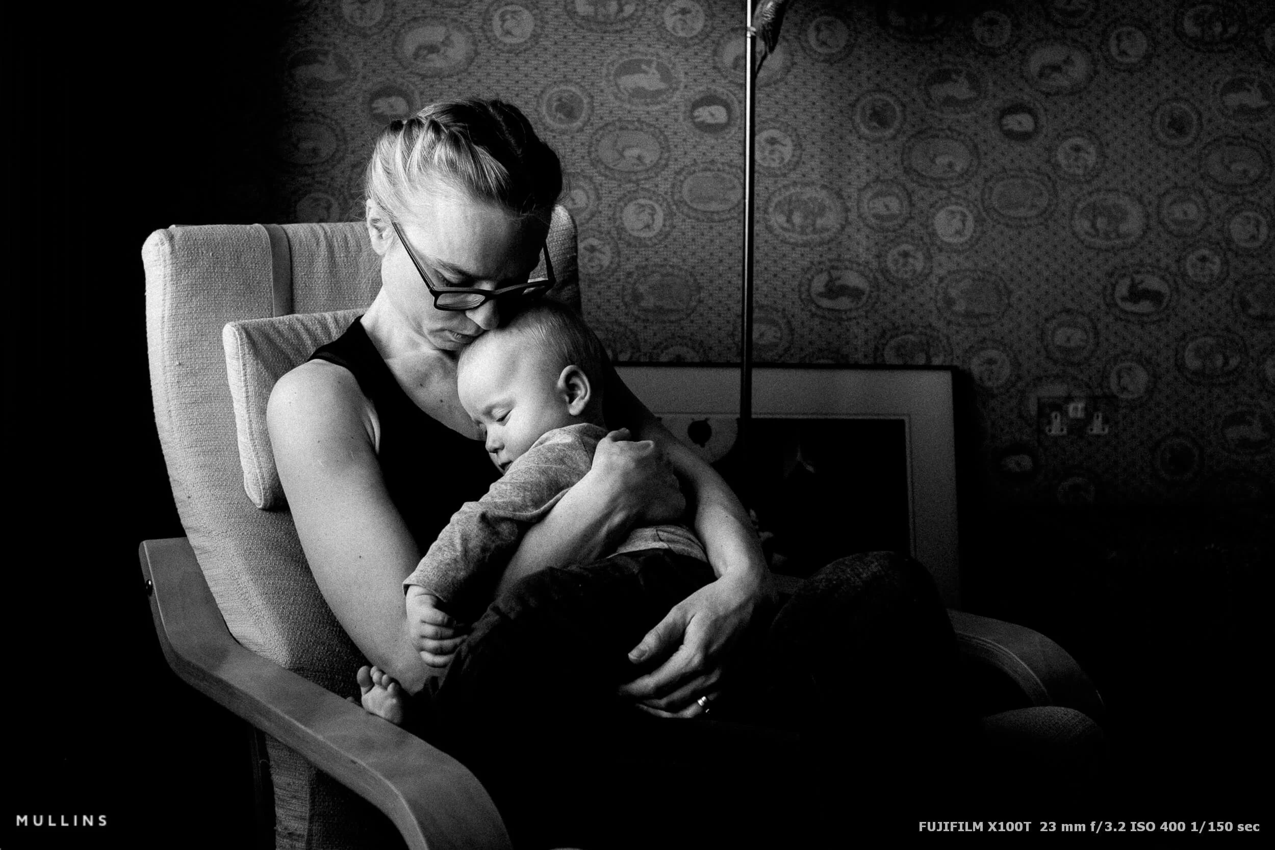 A Black and White Fujifilm X100T Photo of a woman and her baby son.