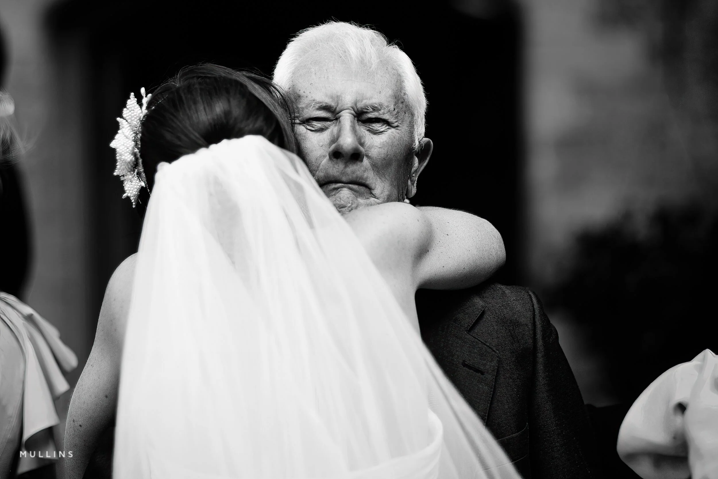 Father and his daughter embrace at a wedding