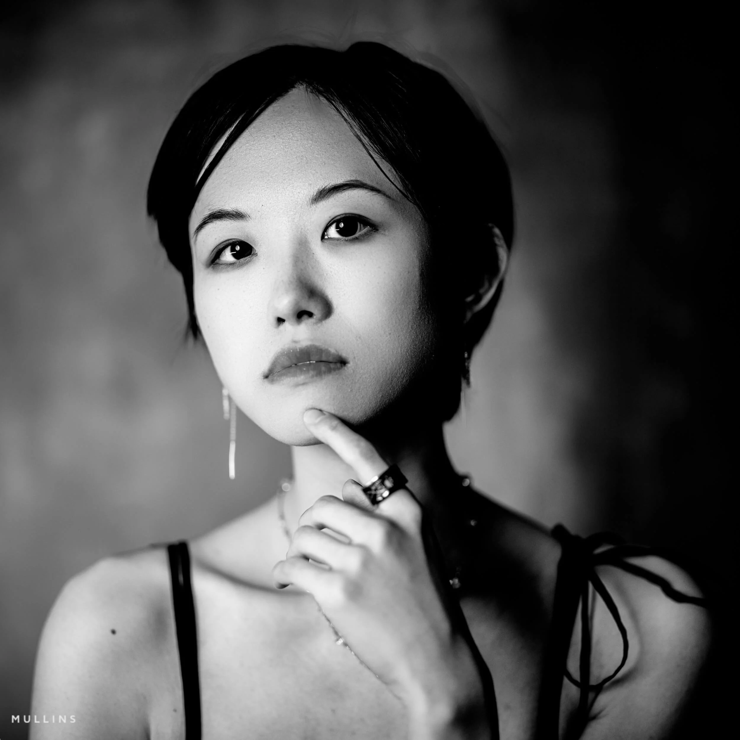 A black and white studio portrait of a woman