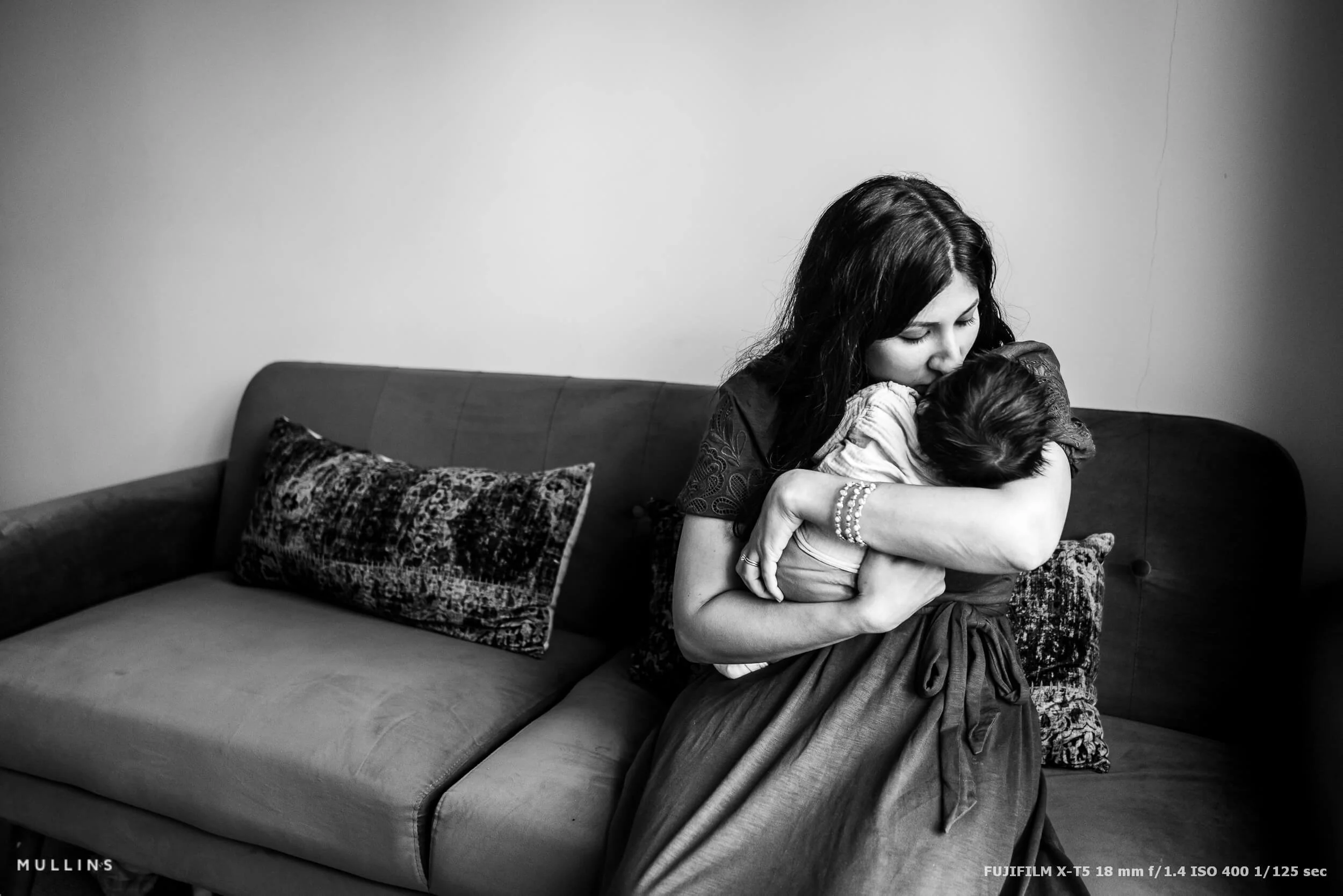 Family moment in soft window light with gentle highlights and natural skin tones