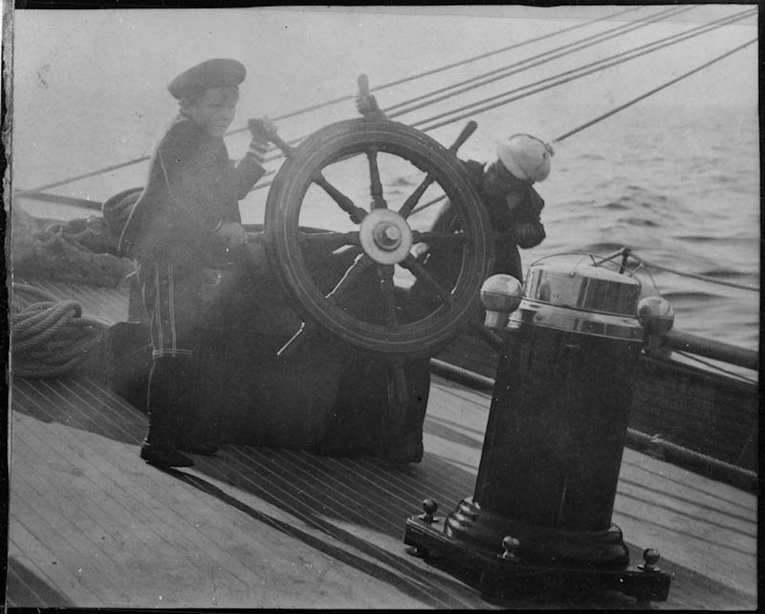 Franklin D. Roosevelt at the helm of his father's yacht "Half Moon" with a Campobello playmate, in a stiff Bay of Fundy breeze (1888).