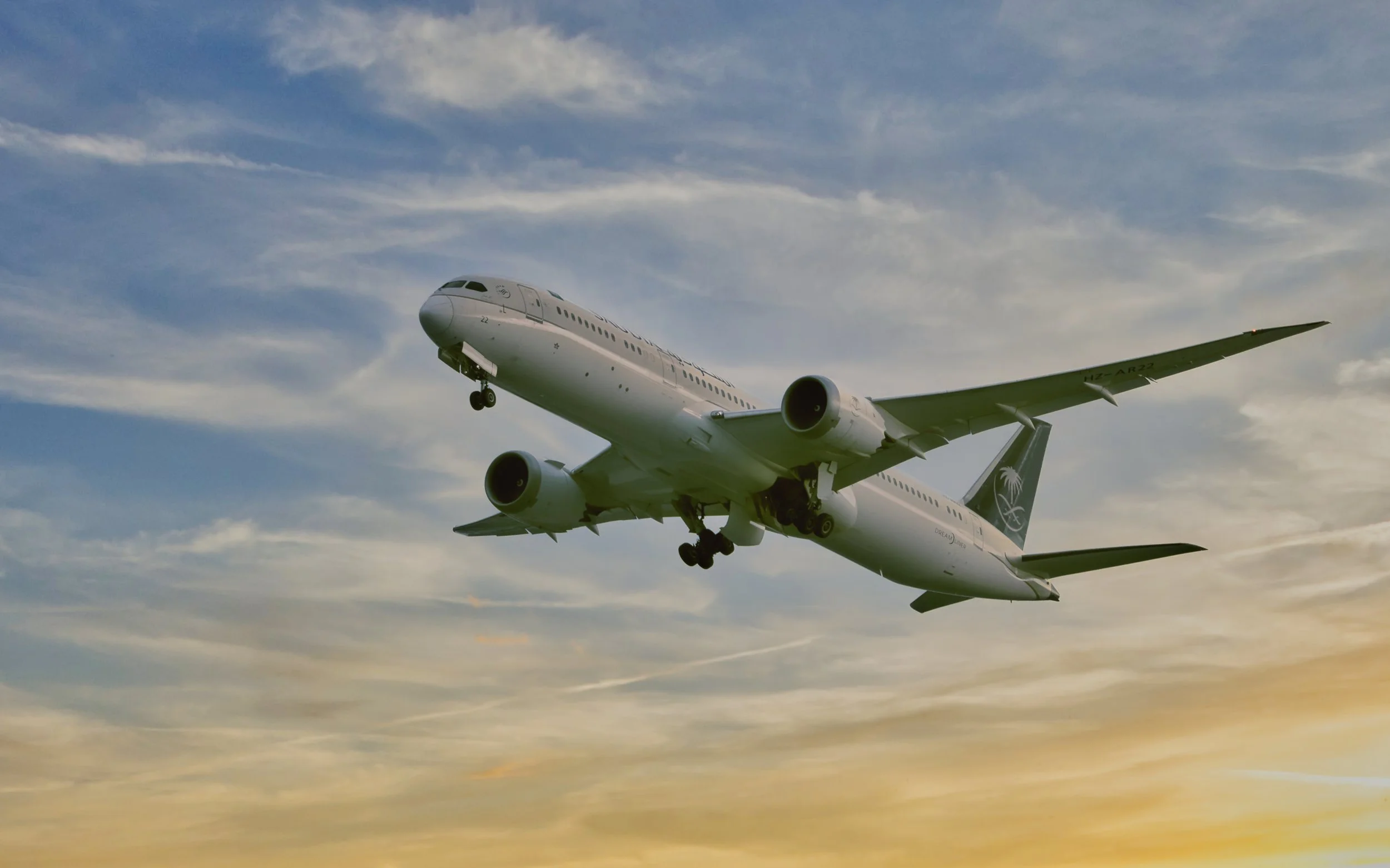 A commercial airplane flying in the sky with clouds.