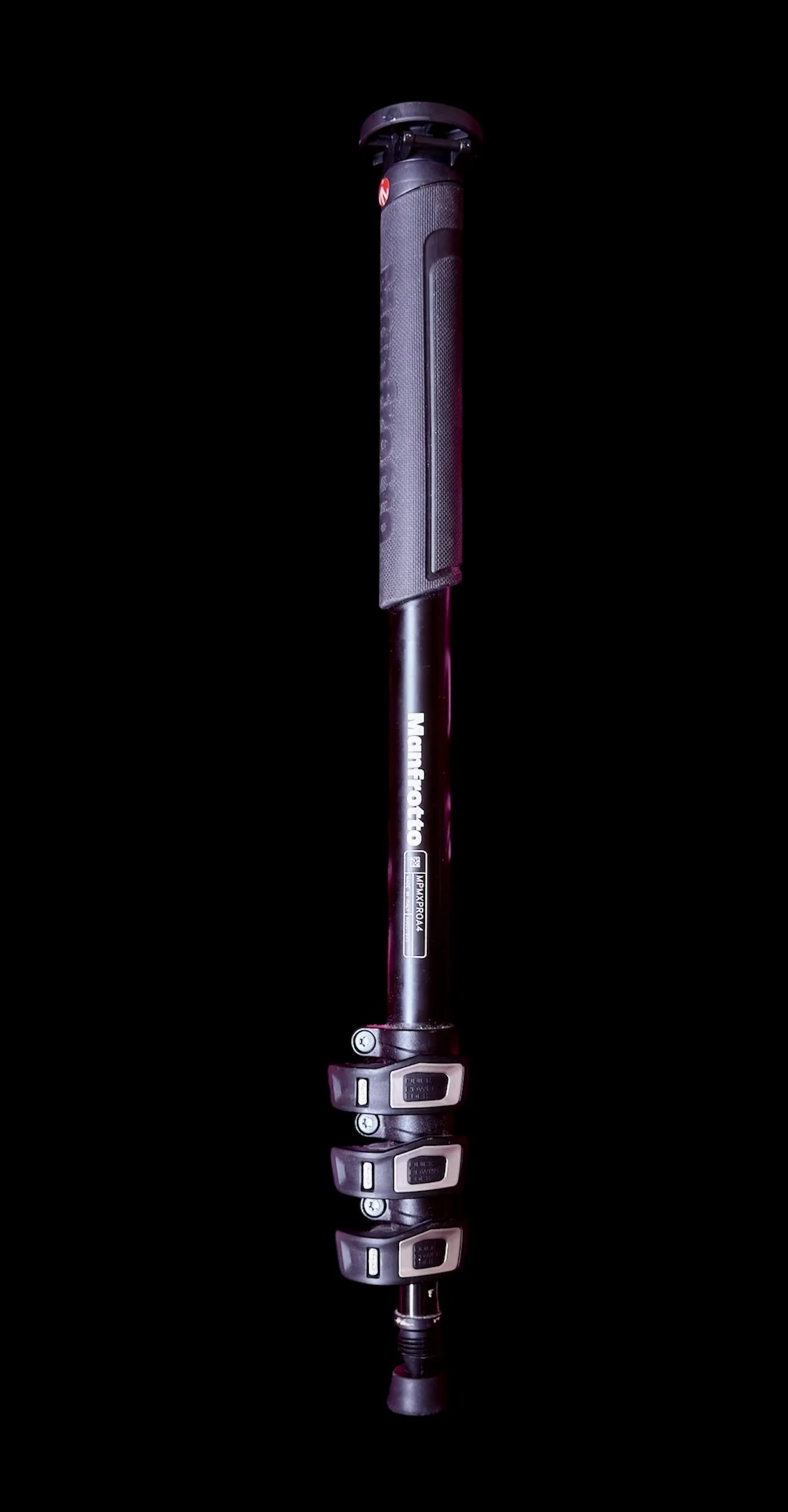A black and purple electric bicycle pump with digital display and control buttons, standing vertically on a reflective black surface.