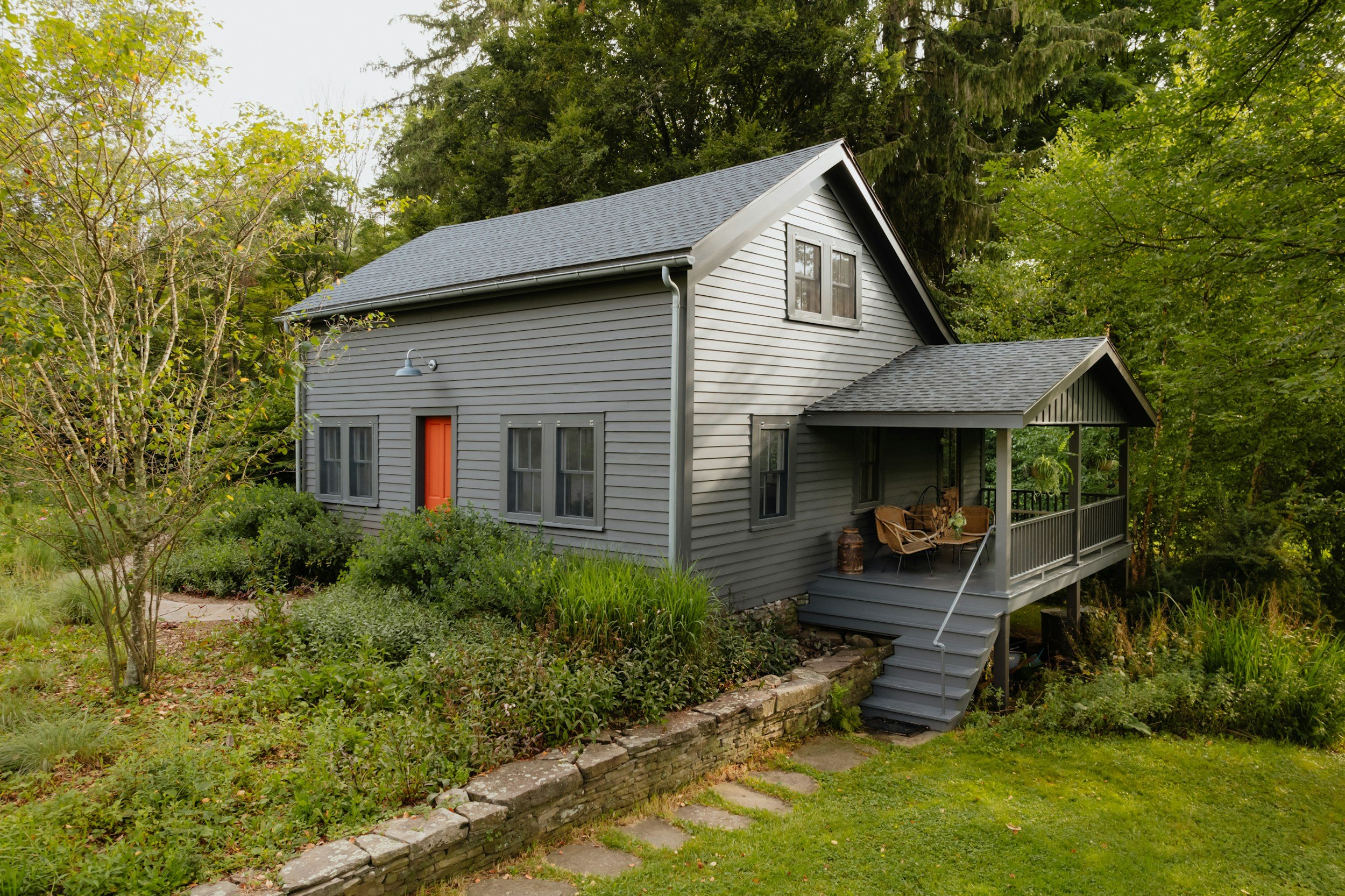 gray house with red door and side porch