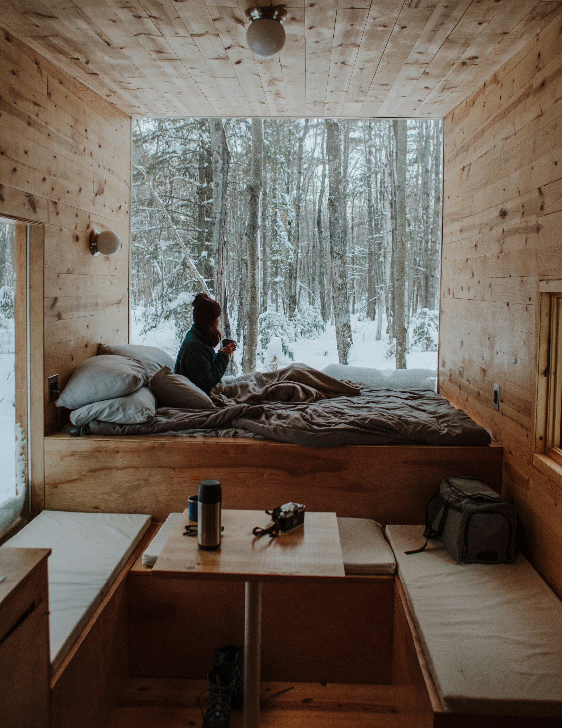 cozy tiny house in the snow with wood clad ceilings and walls