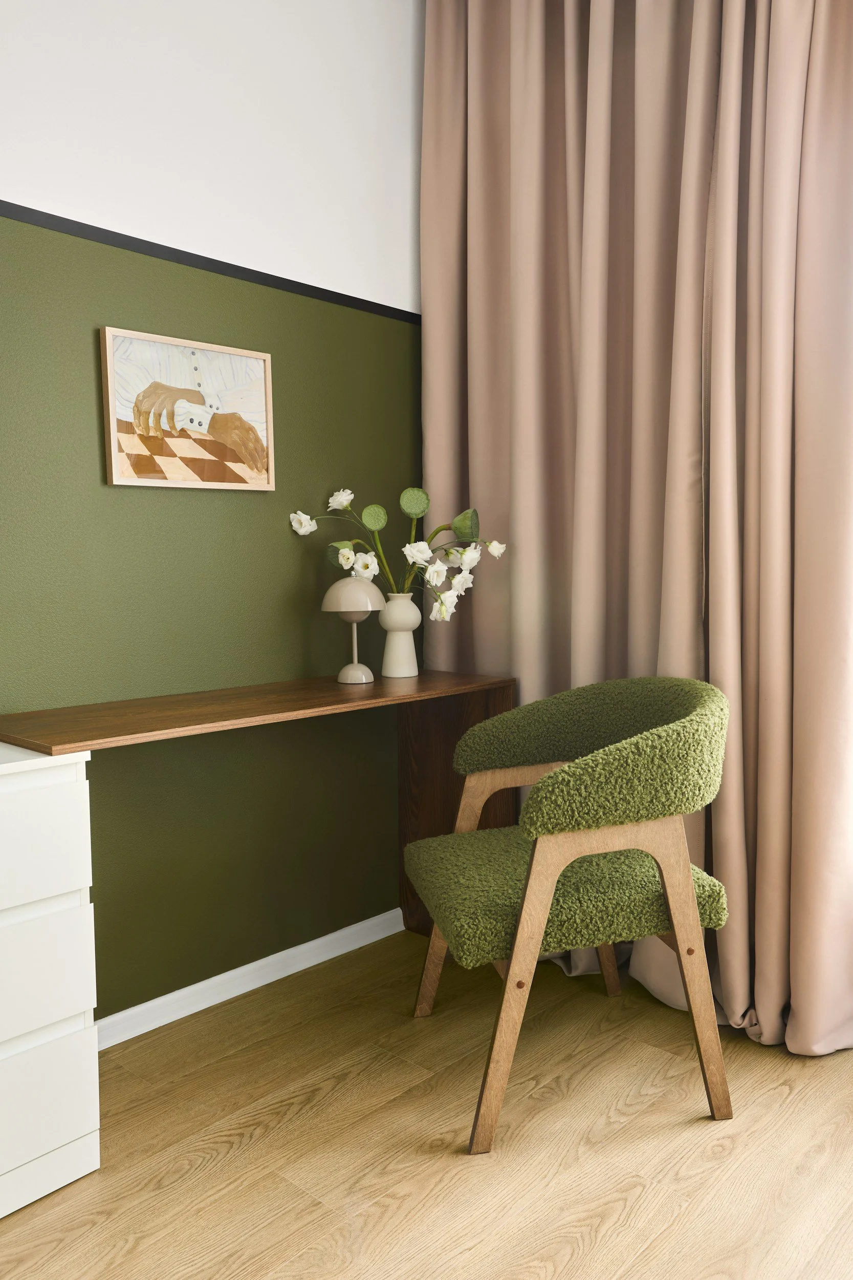 green accent wall with desk and pink curtain