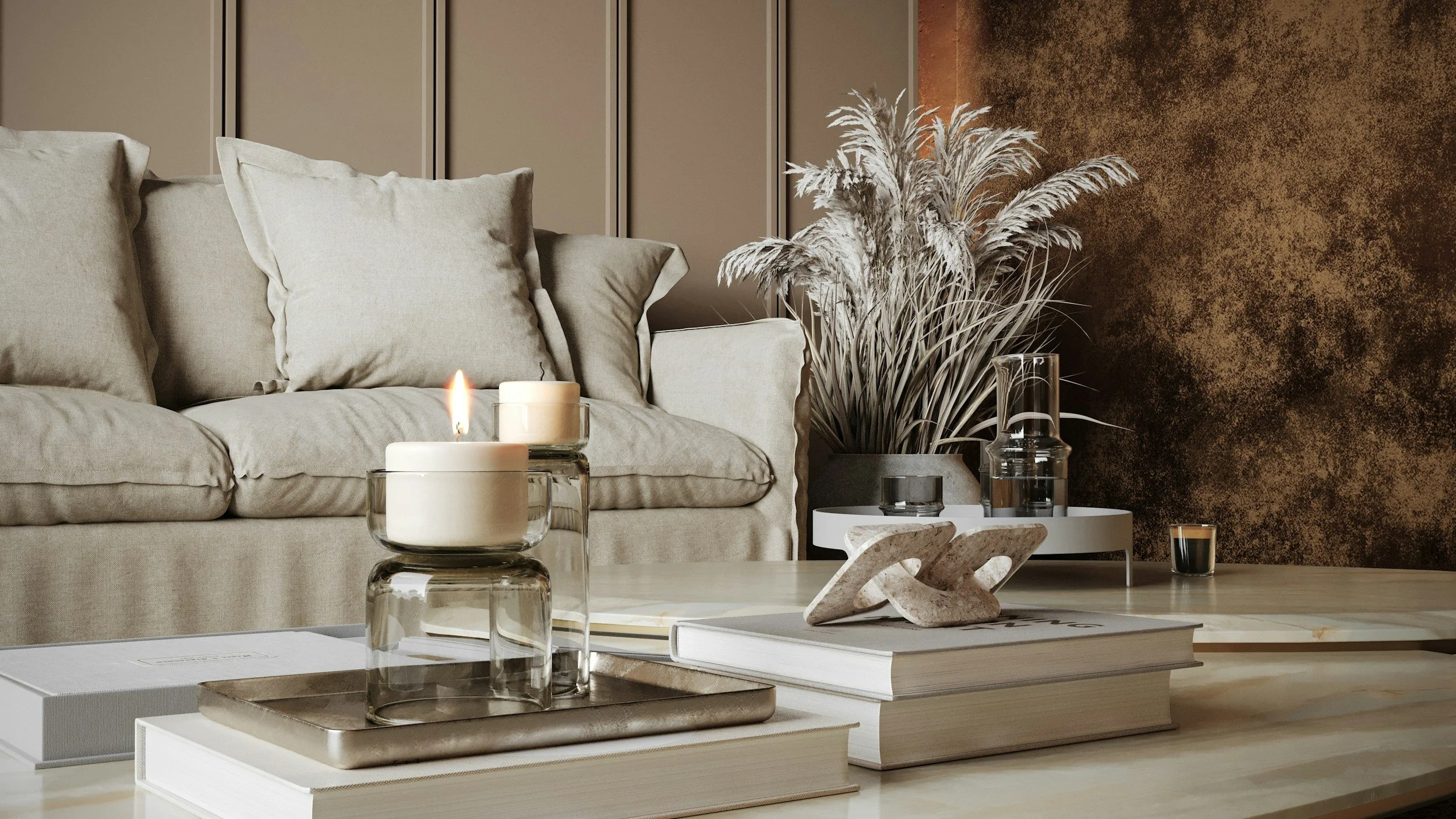 neutral living room with pampas grass, a candle, and a beige sofa
