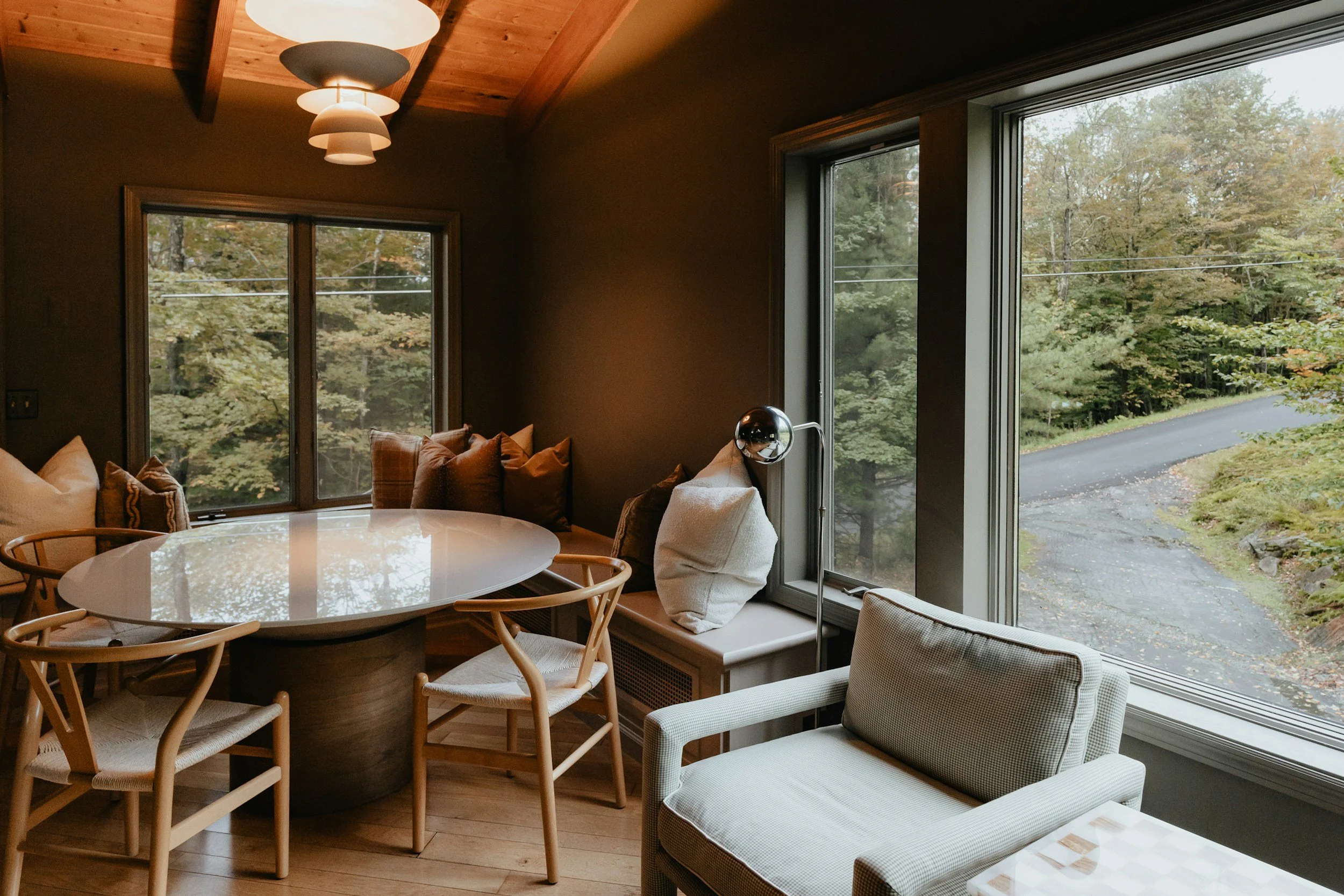 moody dining room with round table and banquet