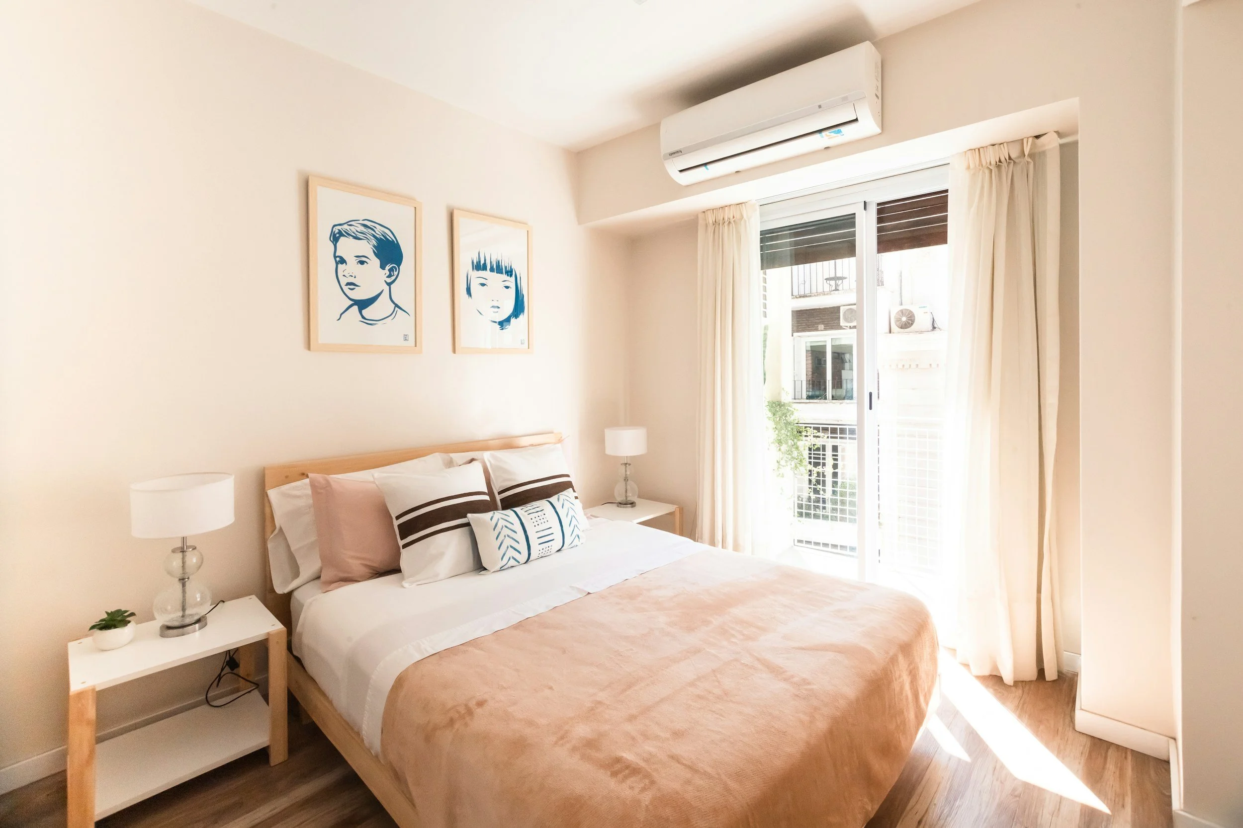 light bedroom with pink quilt