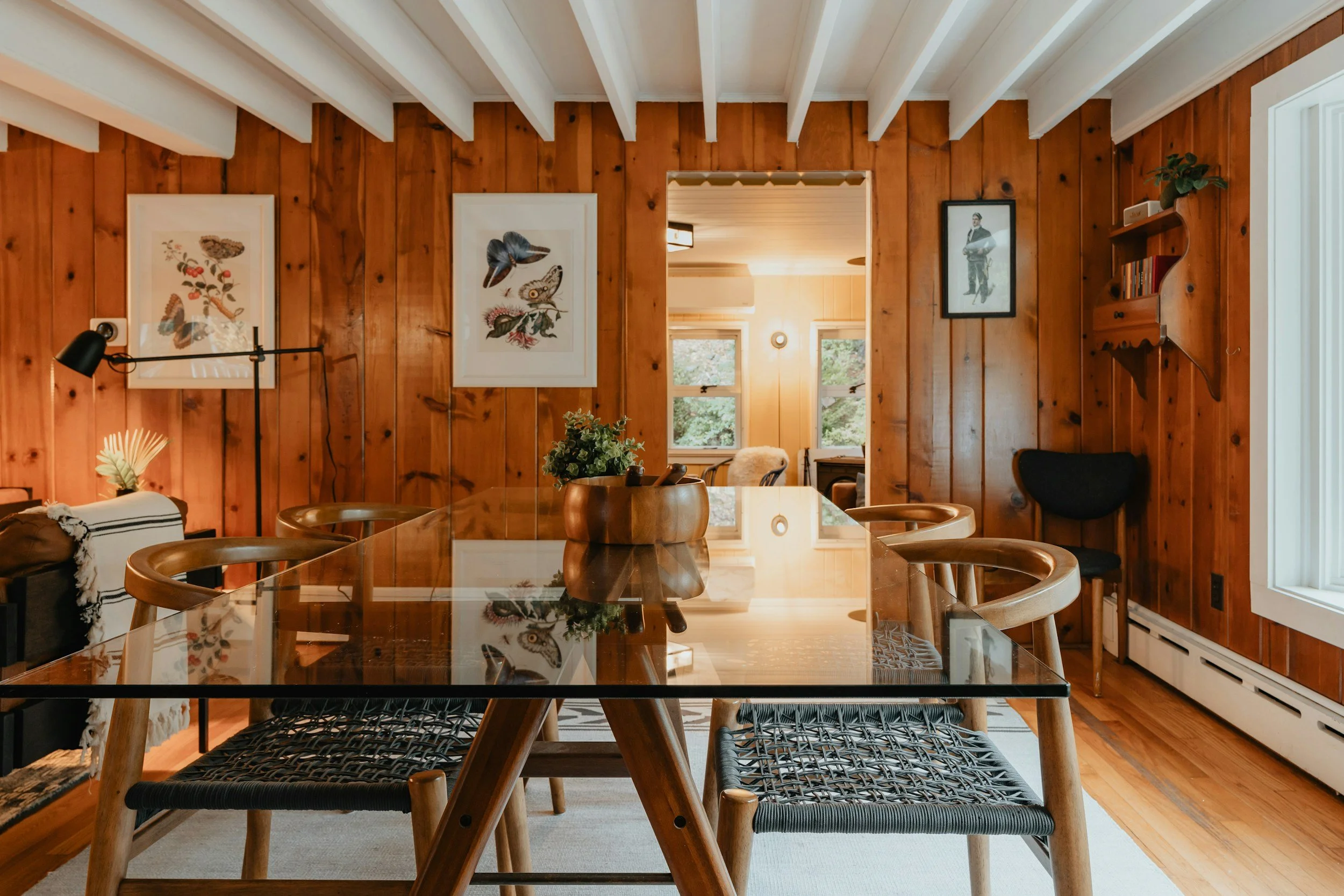 wood paneled dining room with white ceiling beams
