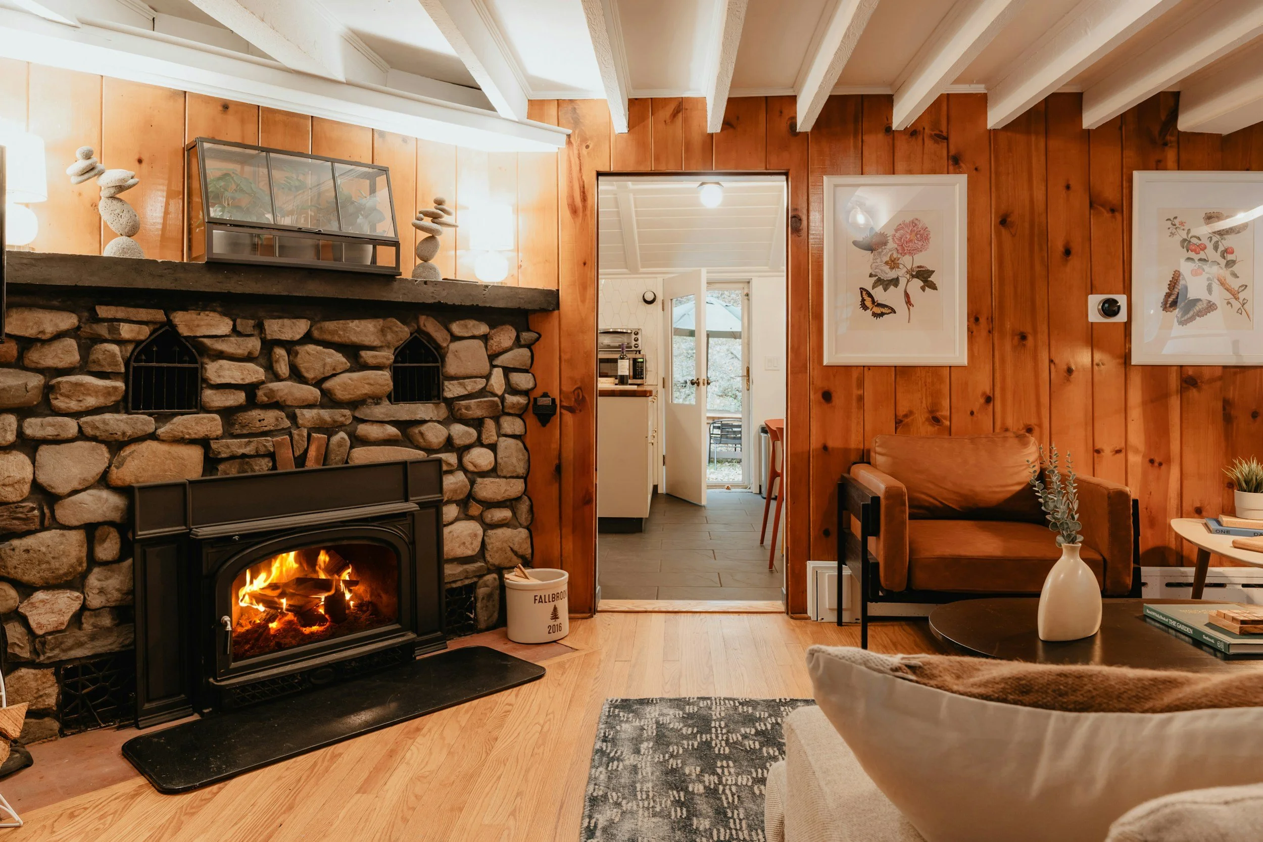 cabin with wood walls and stone fireplace