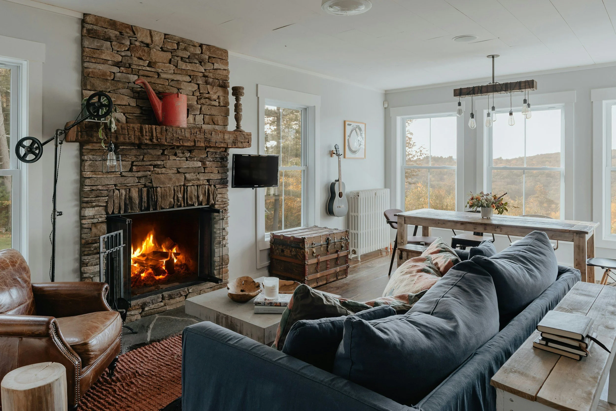 living room with stone fireplace and blue sofa