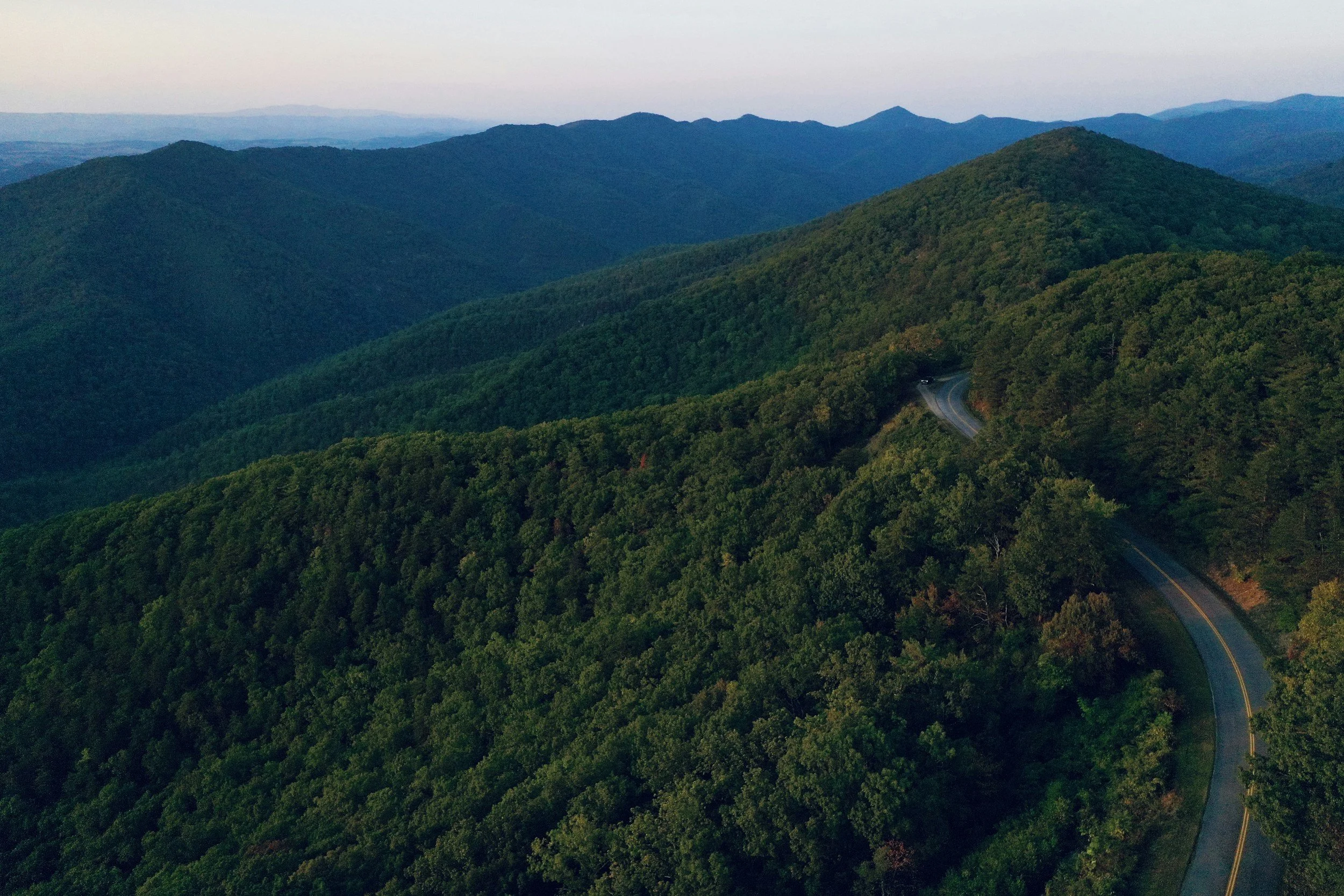 aerial view of the blue ridge parkway winding through the green mountains