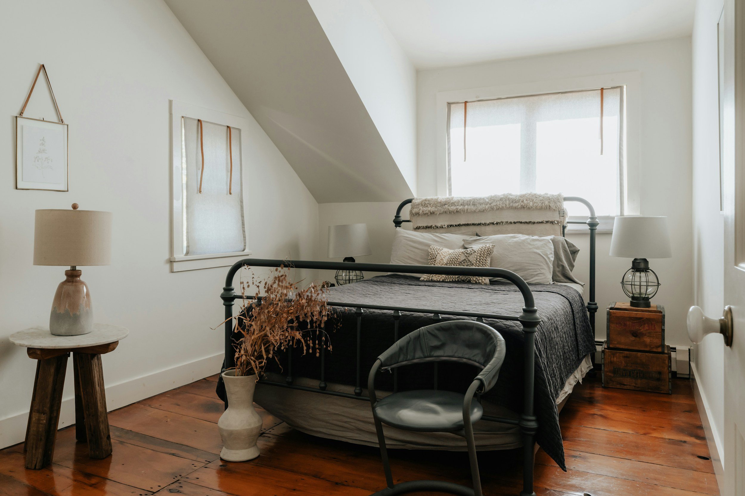 bright bedroom with white walls and vintage furniture