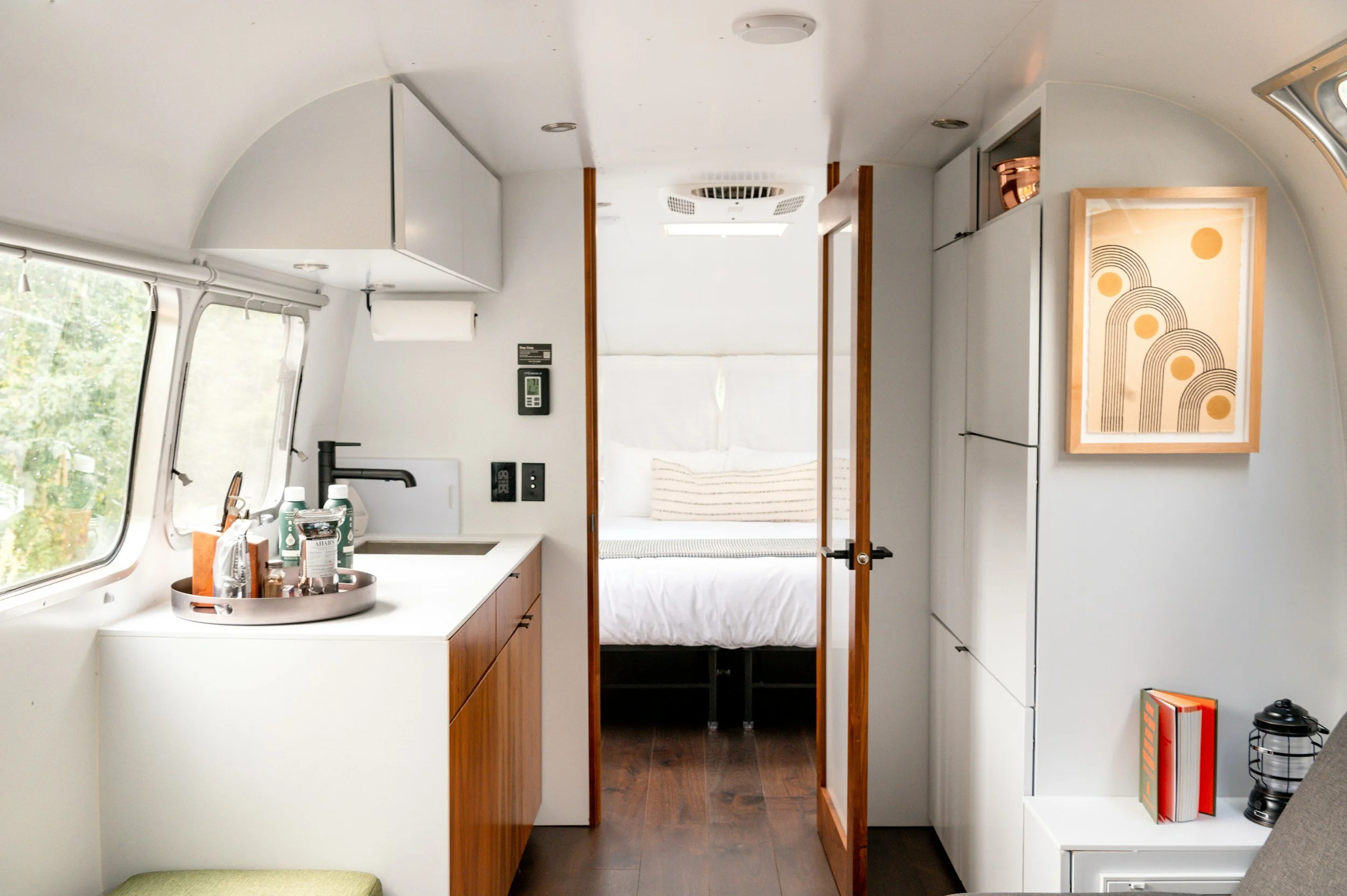 renovated airstream with white walls and walnut cabinets