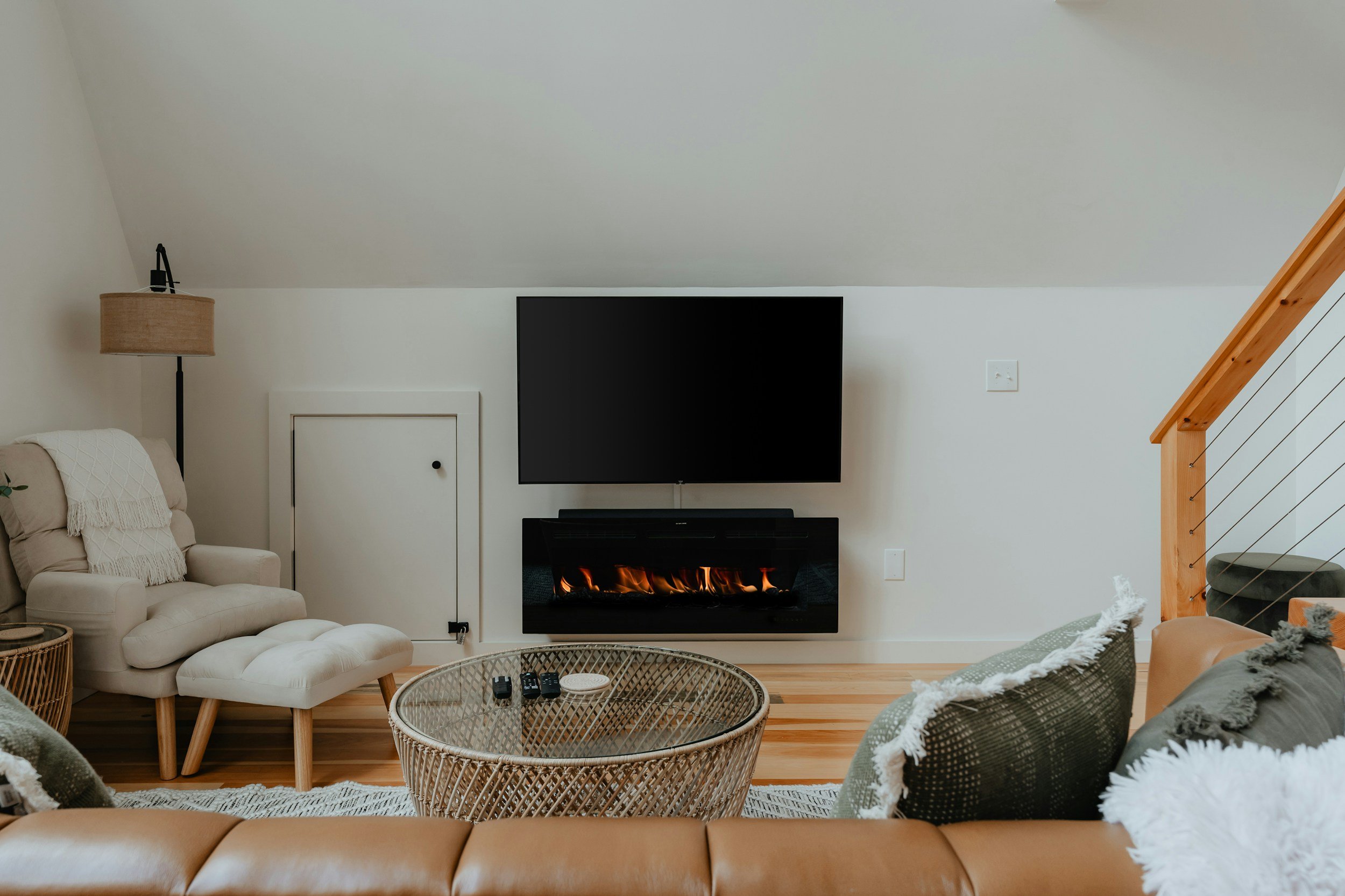 modern boho cabin with fireplace and green pillows