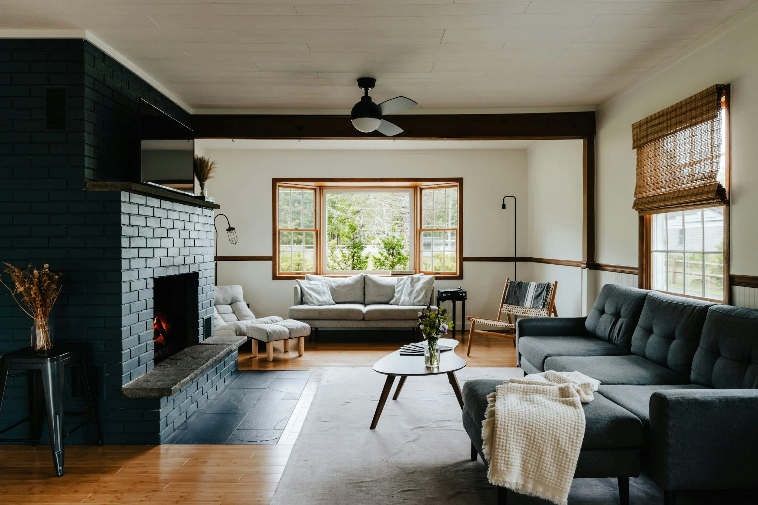 brick brick fireplace with navy sectional sofa
