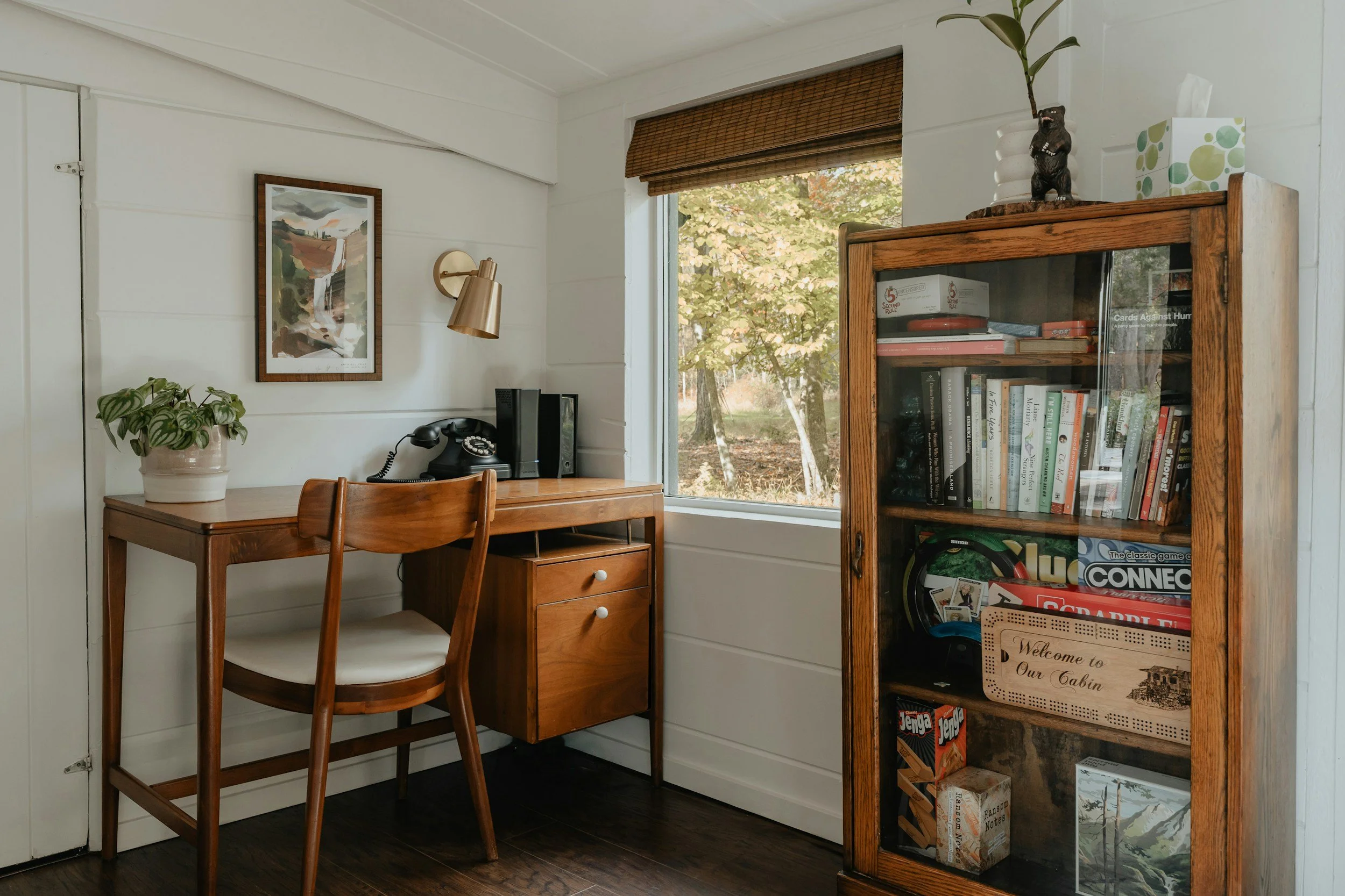 home office with vintage wood desk and mid century sconce