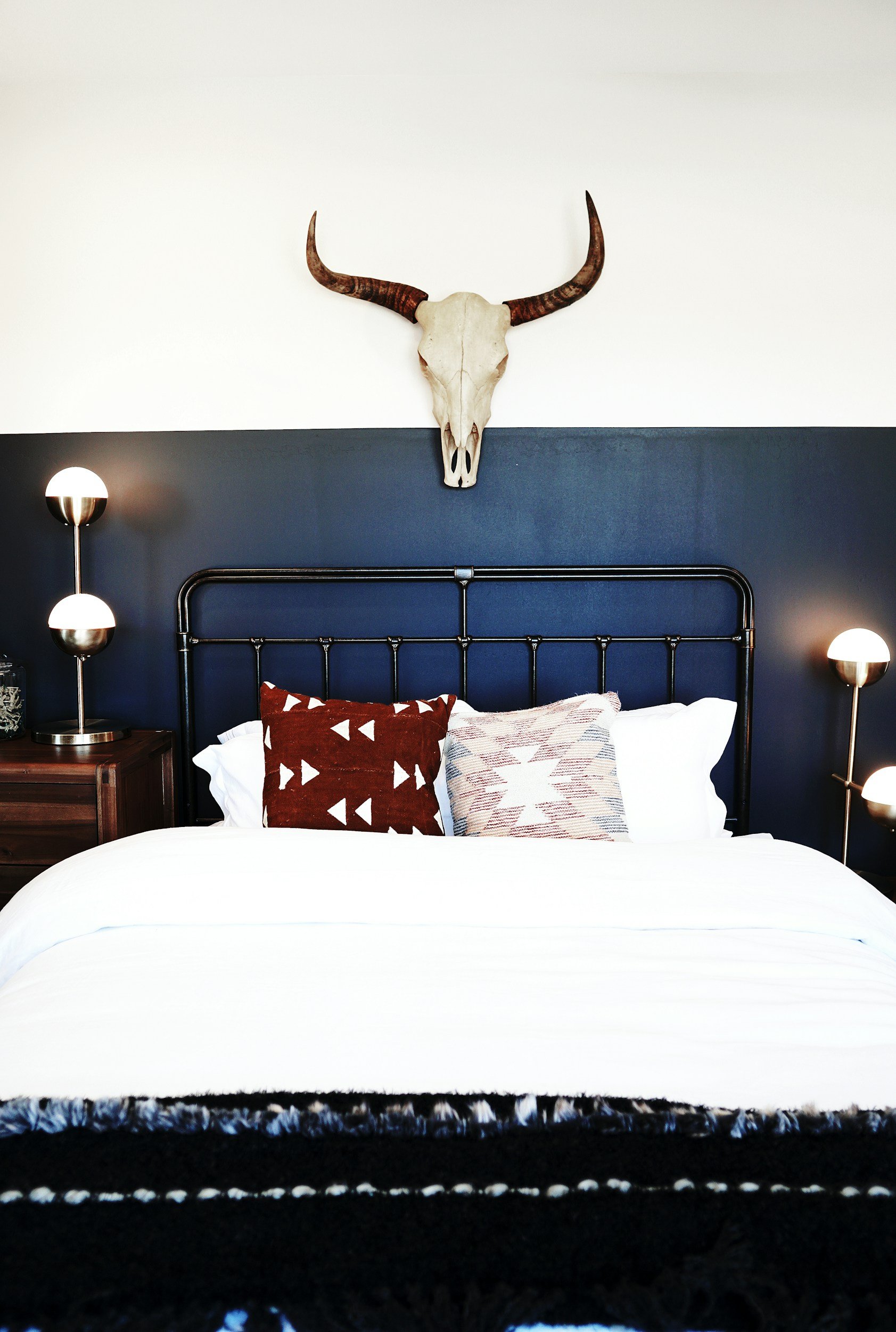 southerwestern bedroom with black painted headboard and skull