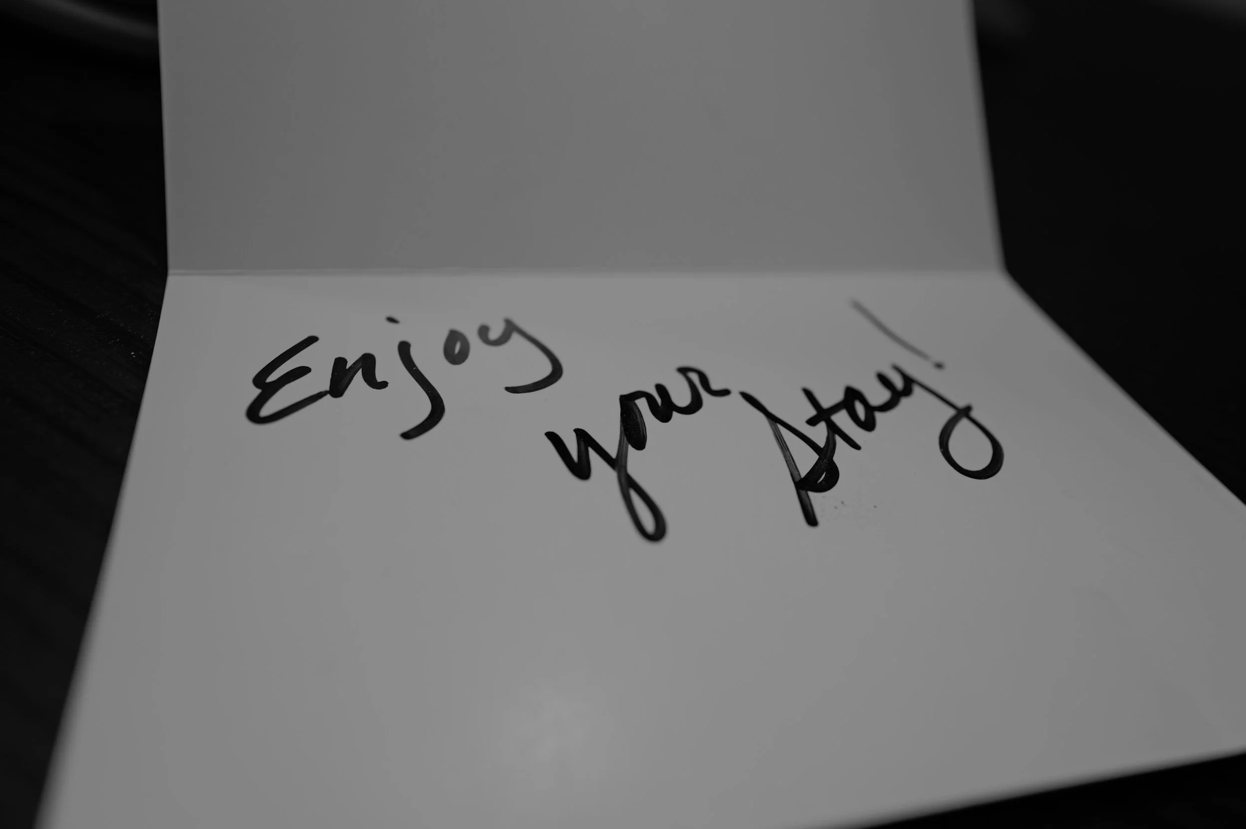 open card that says in handwriting "Enjoy your stay!"