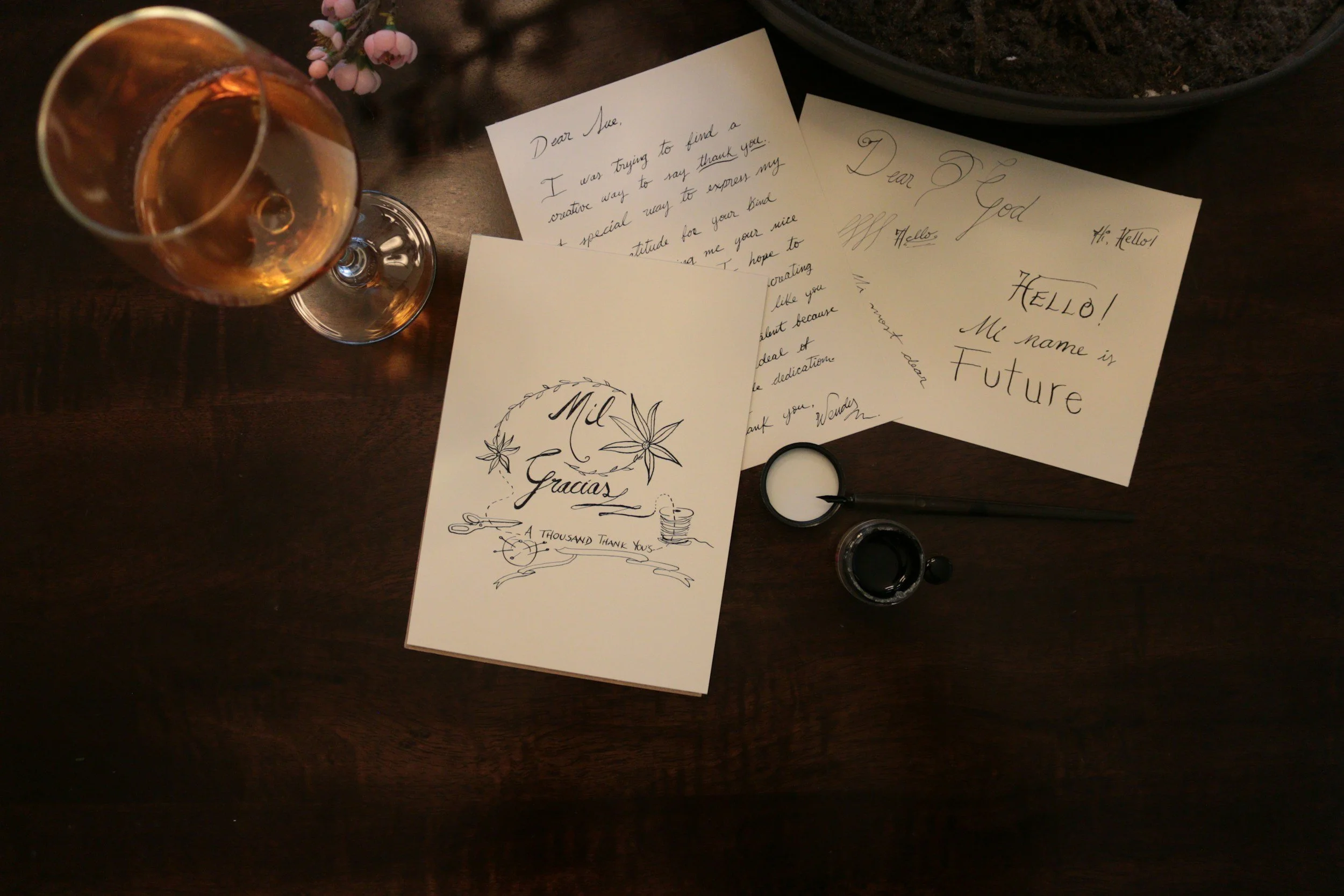 notes and drawings with a glass of wine