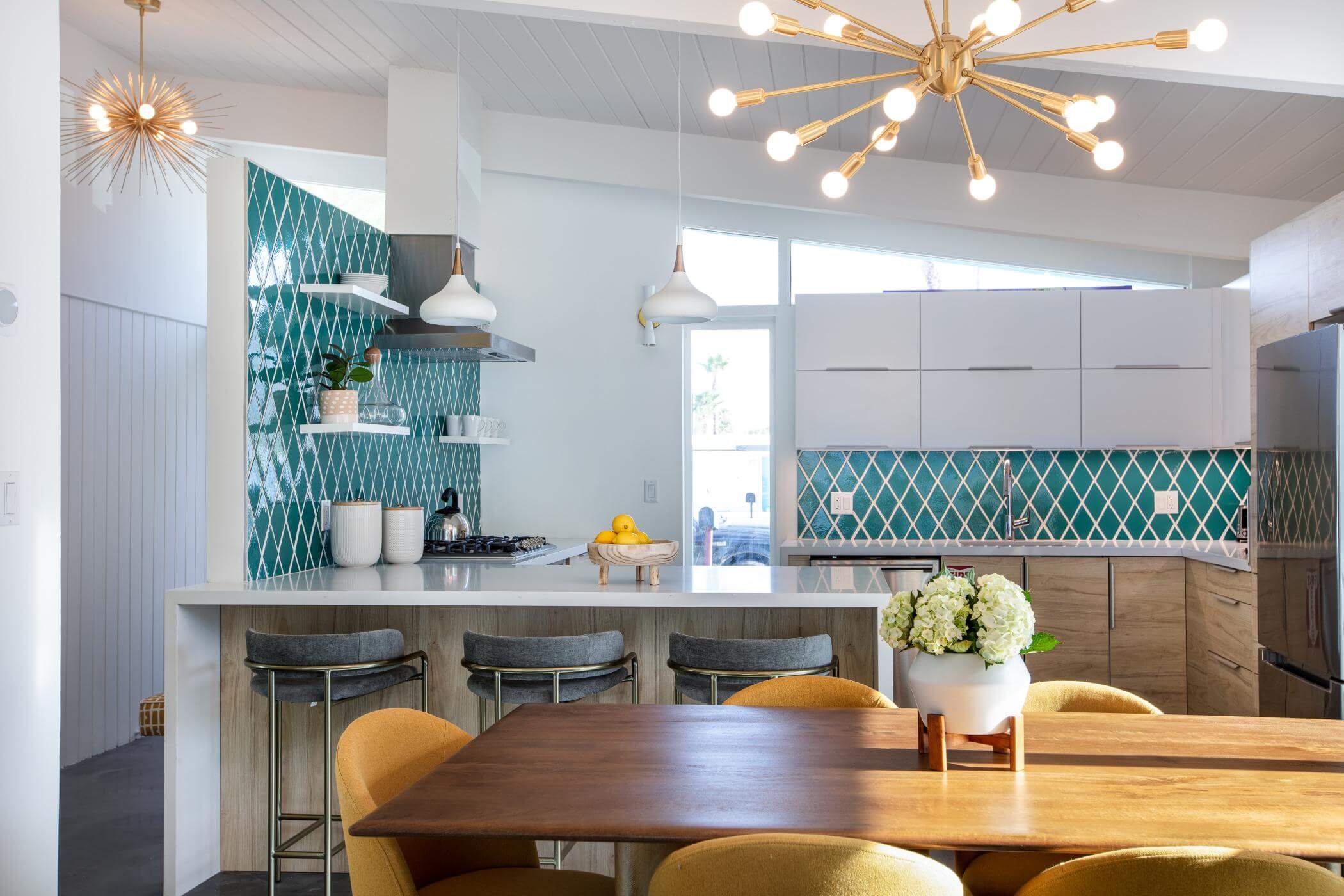 yellow chairs and teal tile backsplash