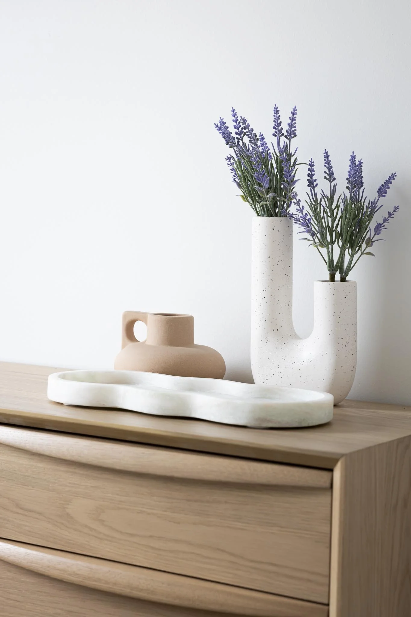 clay vase with lavender and white ceramic tray