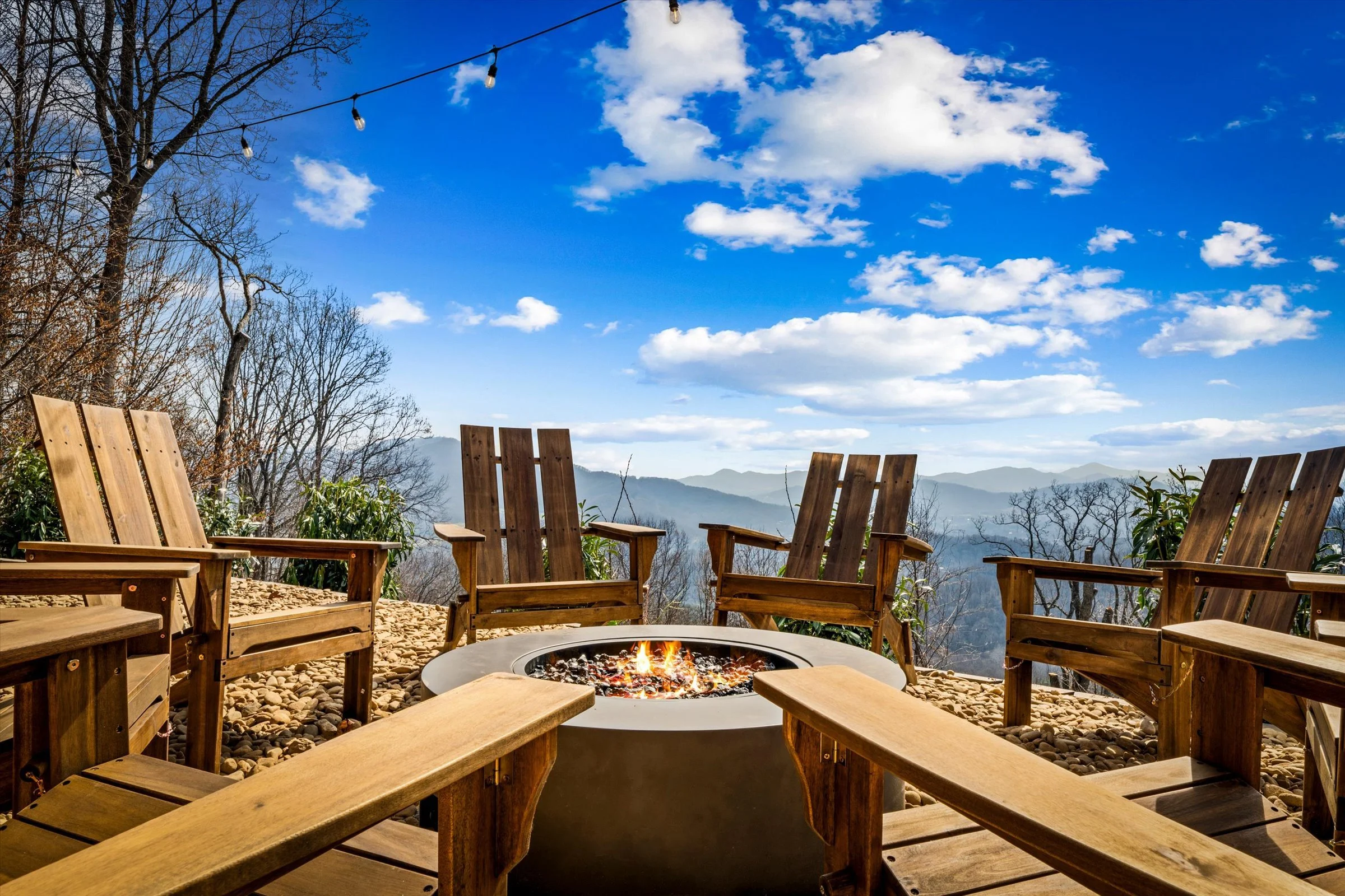 firepit with adirondack chairs and mountain views