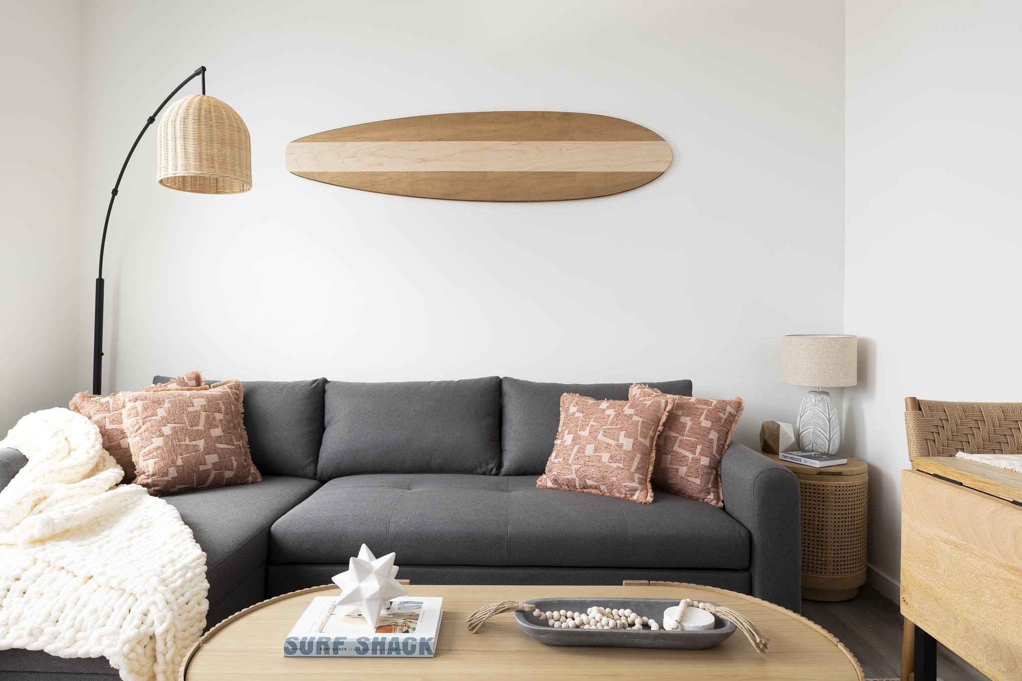 cali living room with surfboard and pink throw pillows