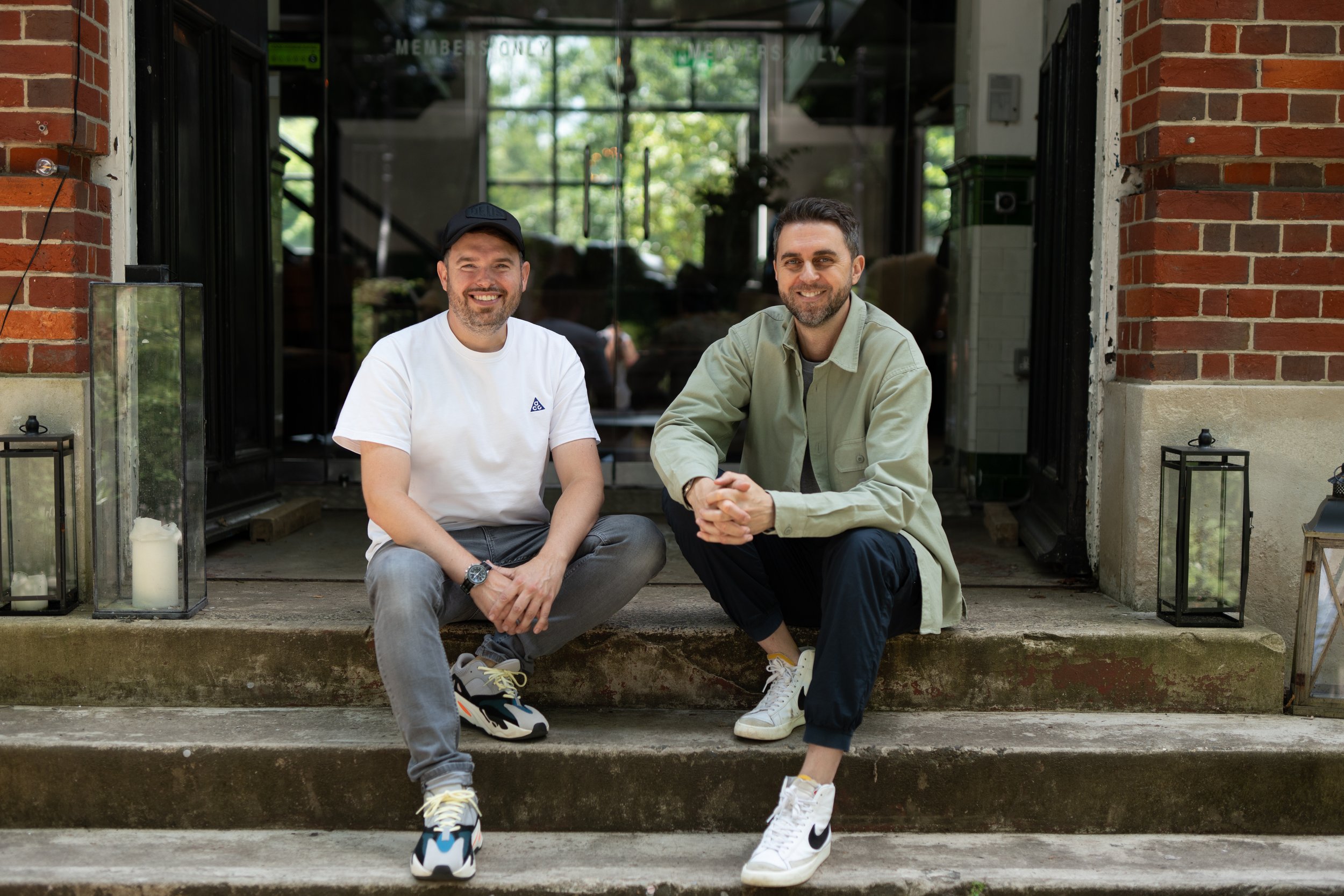 Matt and Nick, partners of Glassup &amp; Stoski sit on the steps outside the office in Winchester