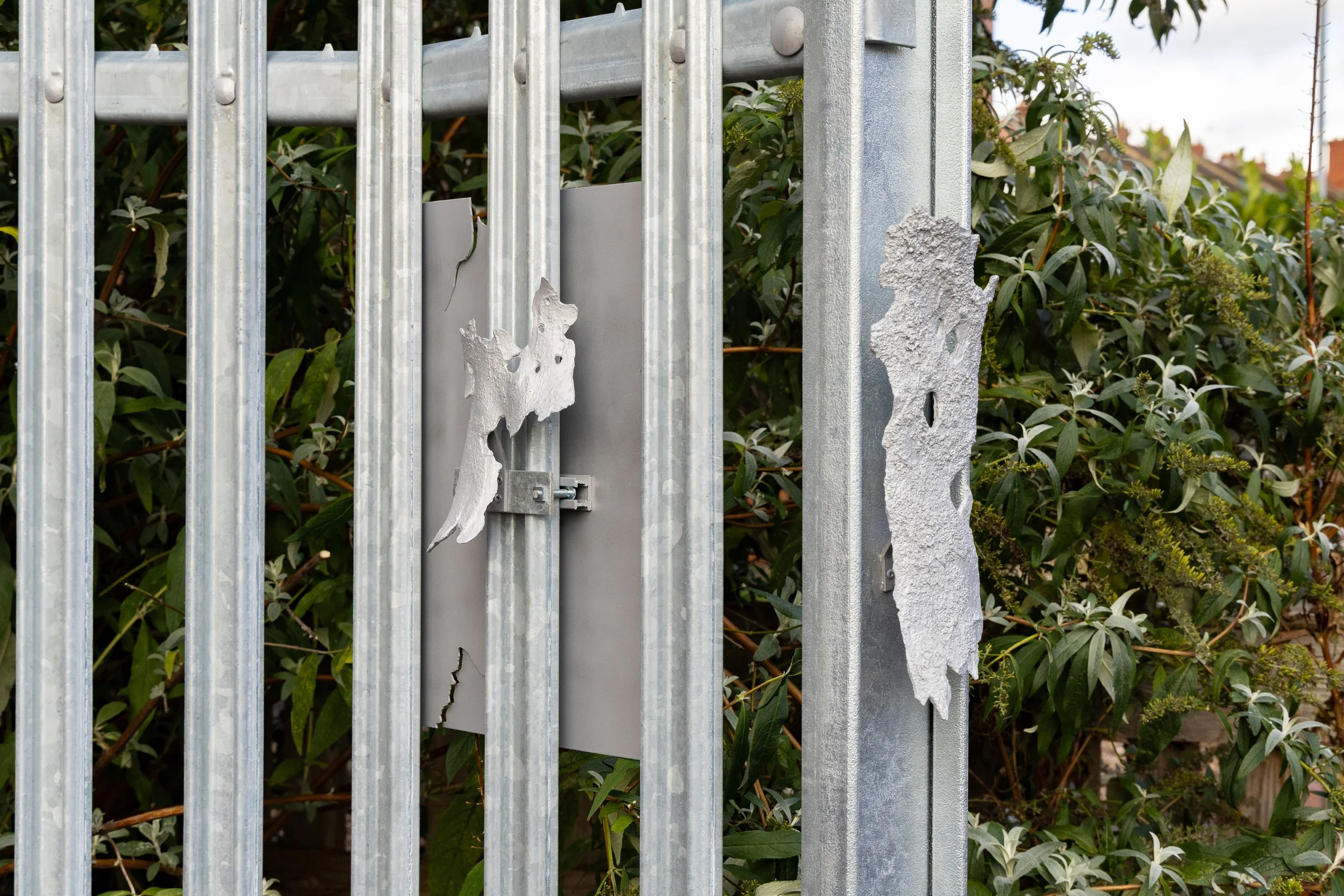 Galvanised security fence with cast London plane tree bark. Artwork by Ian Jackson at Threshold, Leeds.
