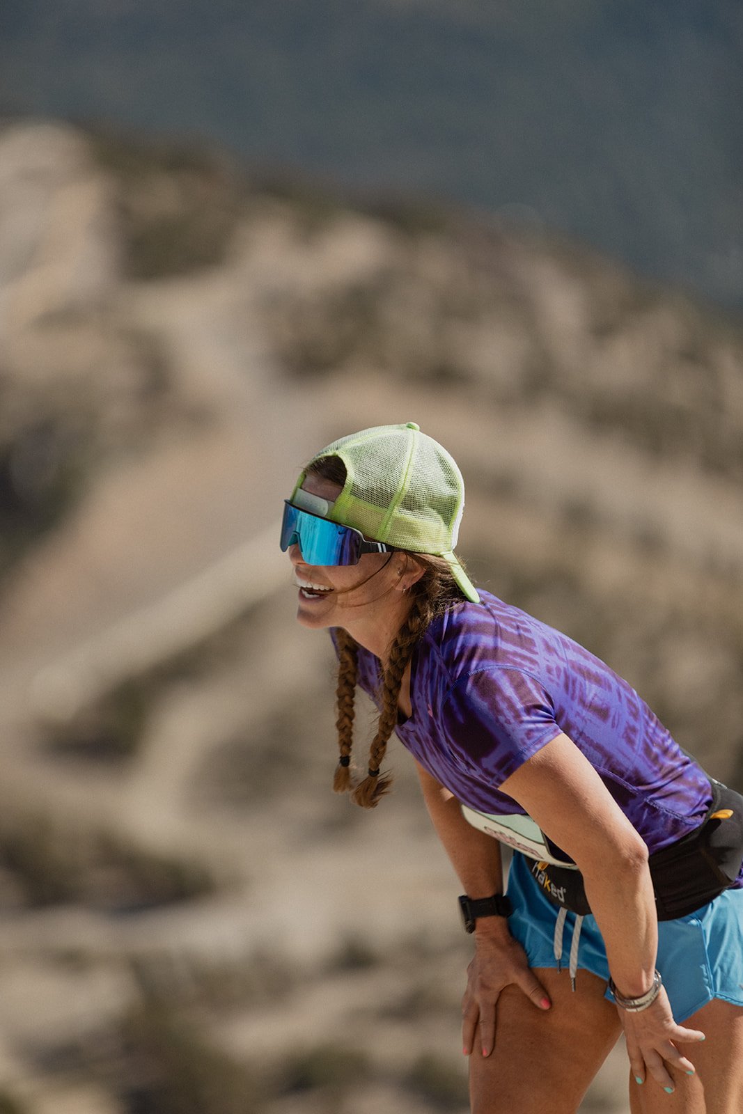 A female runner looking exhausted climbing up the hill at mammoth trail fest