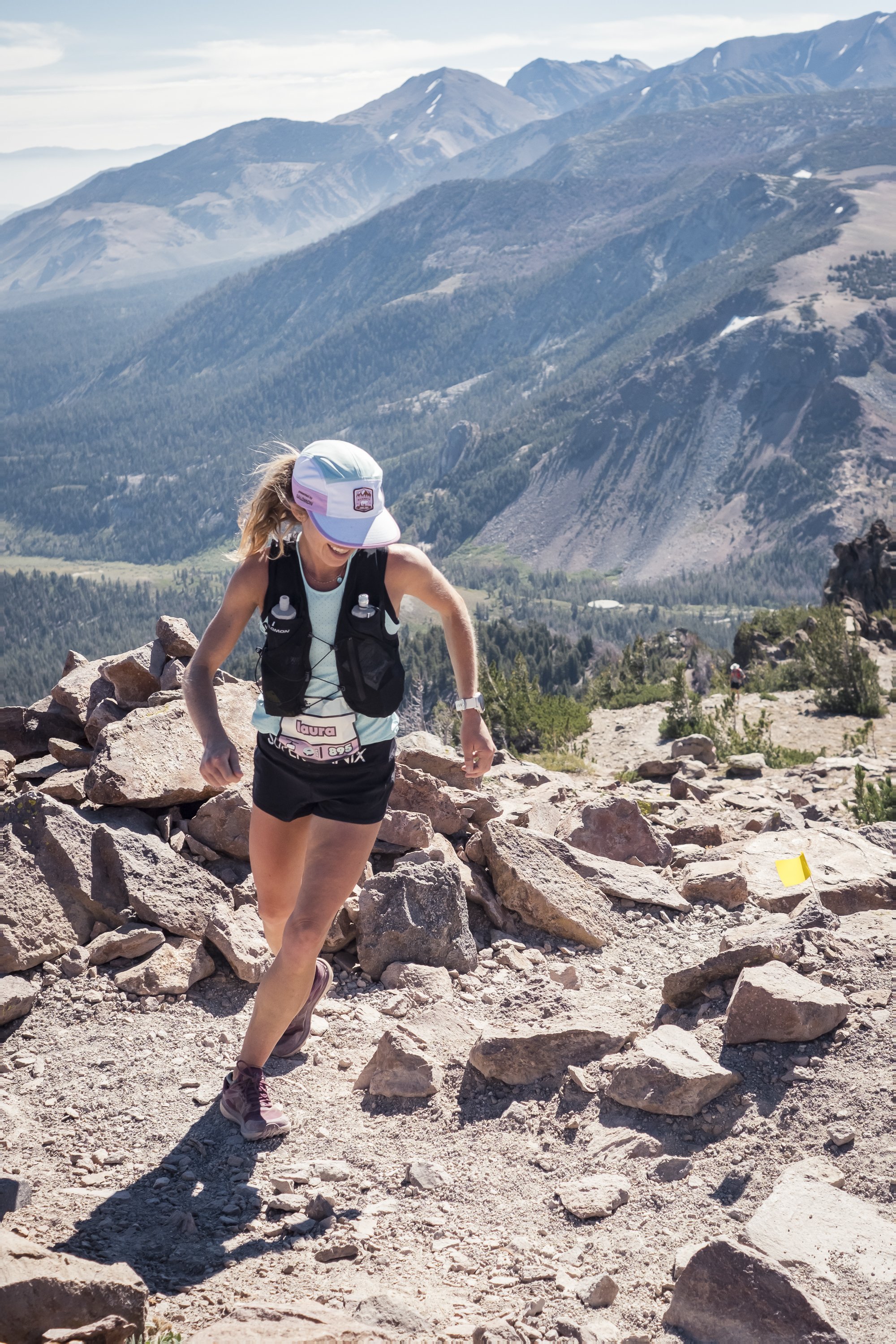A female runner climbing up to the top of mammoth mountain