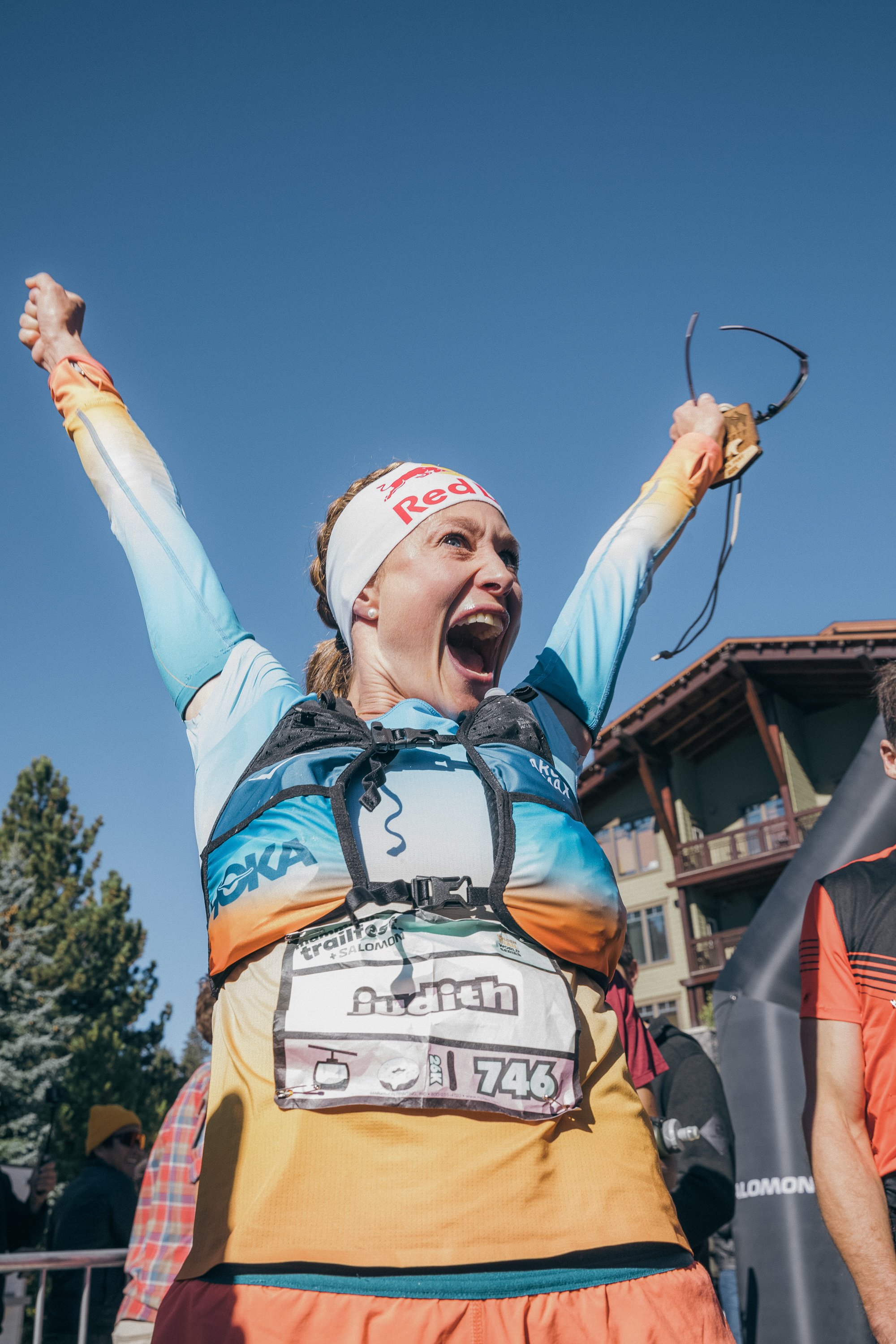 A female runner excited at the finish line of mammoth trail fest